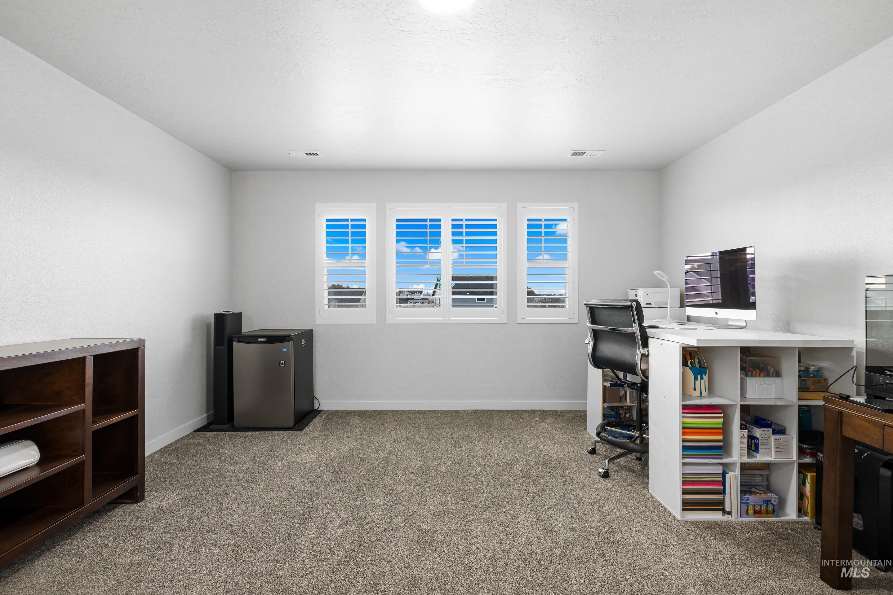 Office area with light carpet and baseboards