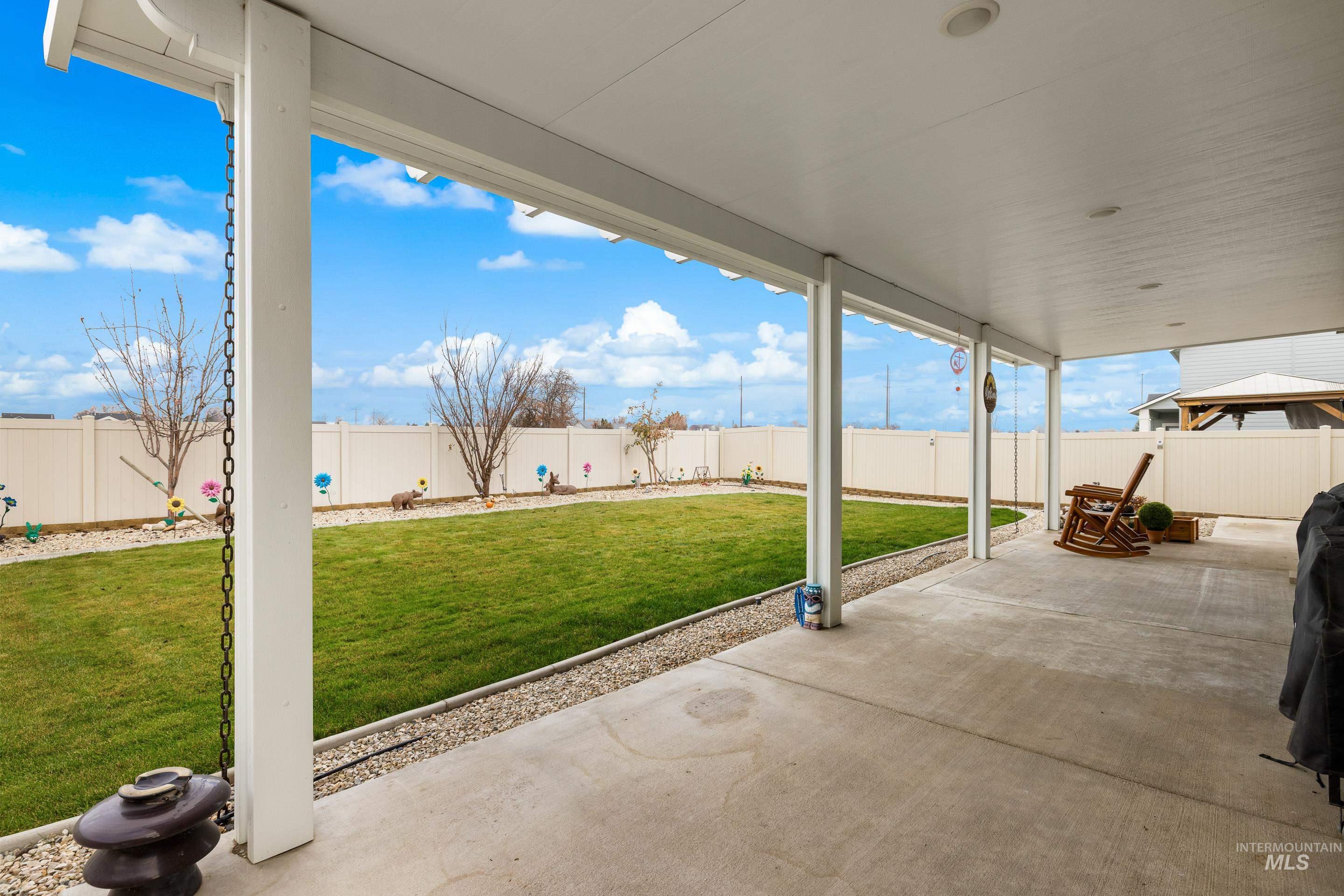 Fenced backyard with a patio