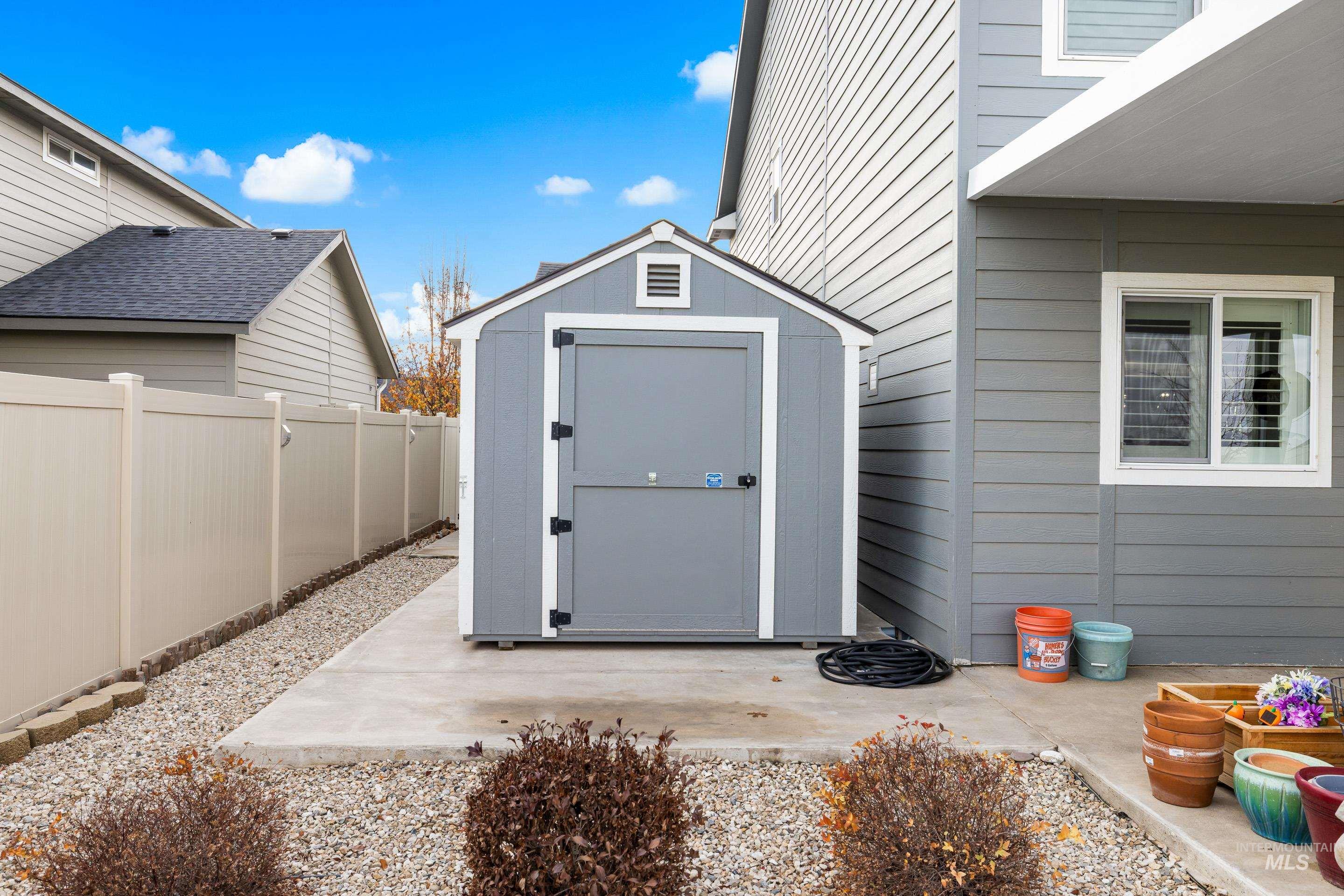 View of shed with a fenced backyard
