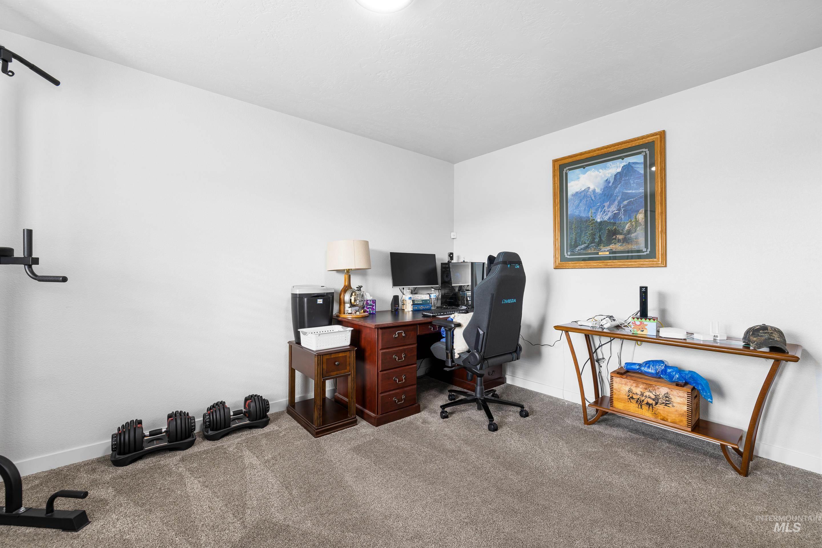 Carpeted office space with baseboards