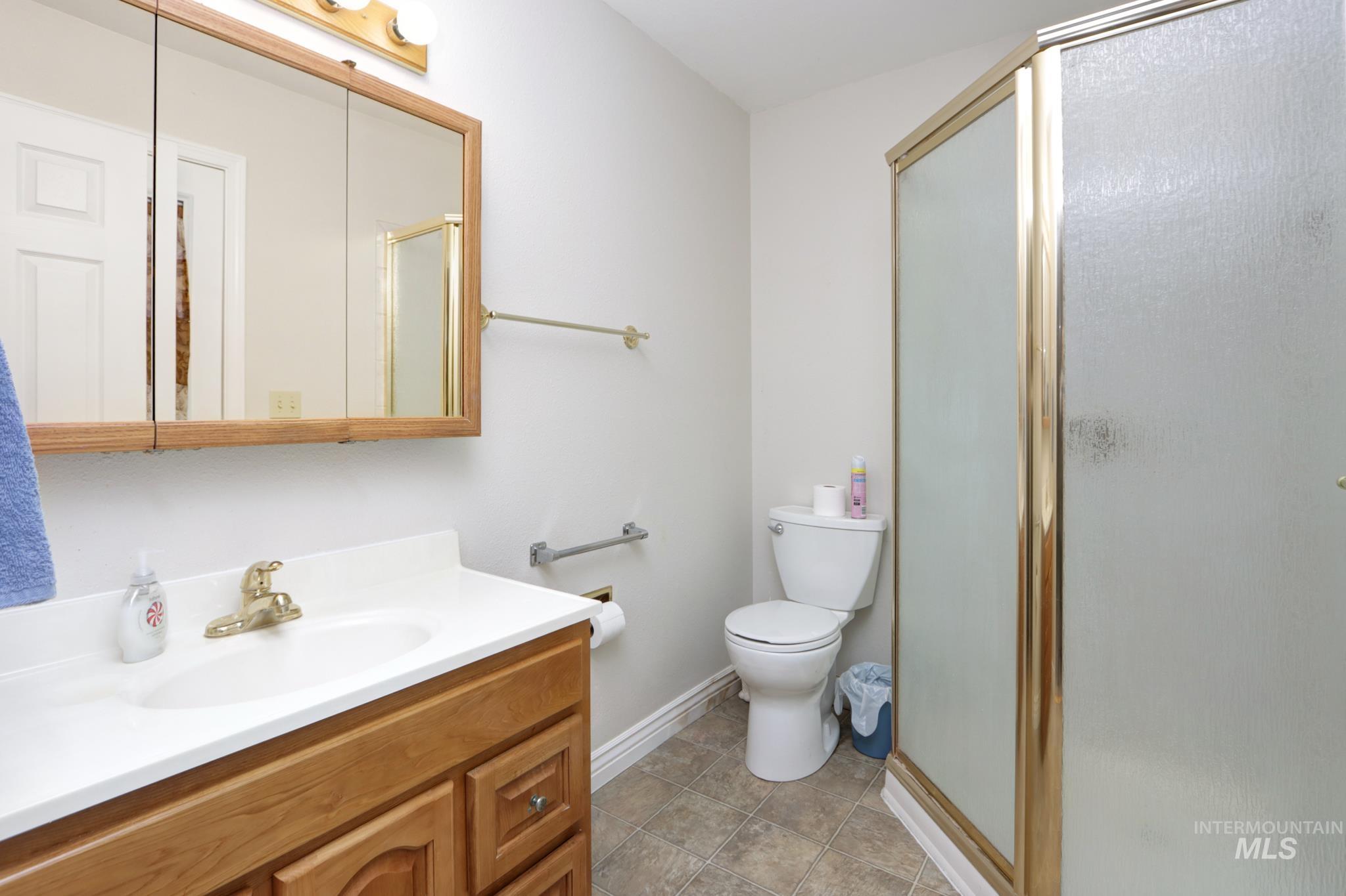 Full bathroom featuring vanity and a shower stall