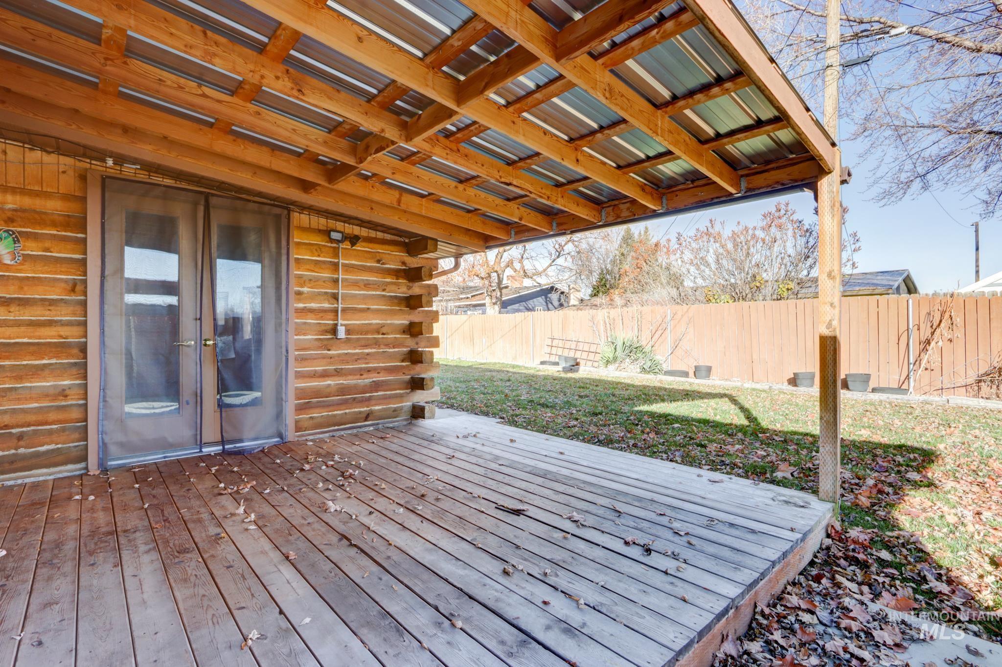 Deck featuring a fenced backyard and french doors