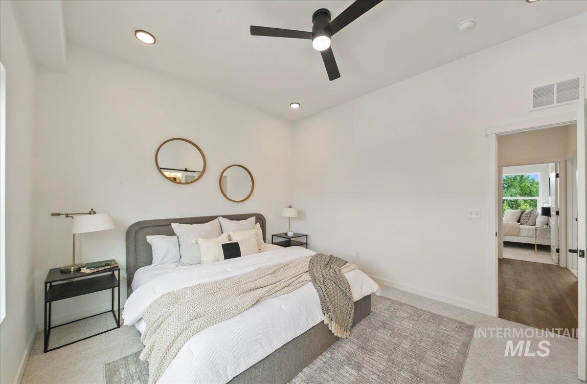 Bedroom with carpet, ceiling fan, and recessed lighting
