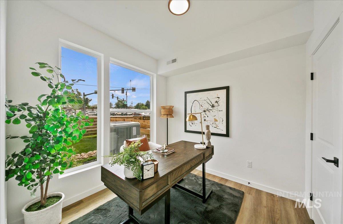 Office space featuring light wood-type flooring and baseboards