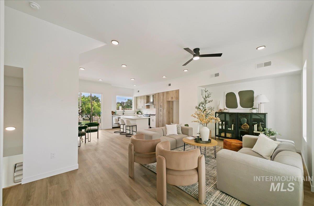 Living area with recessed lighting, light wood-type flooring, and a ceiling fan