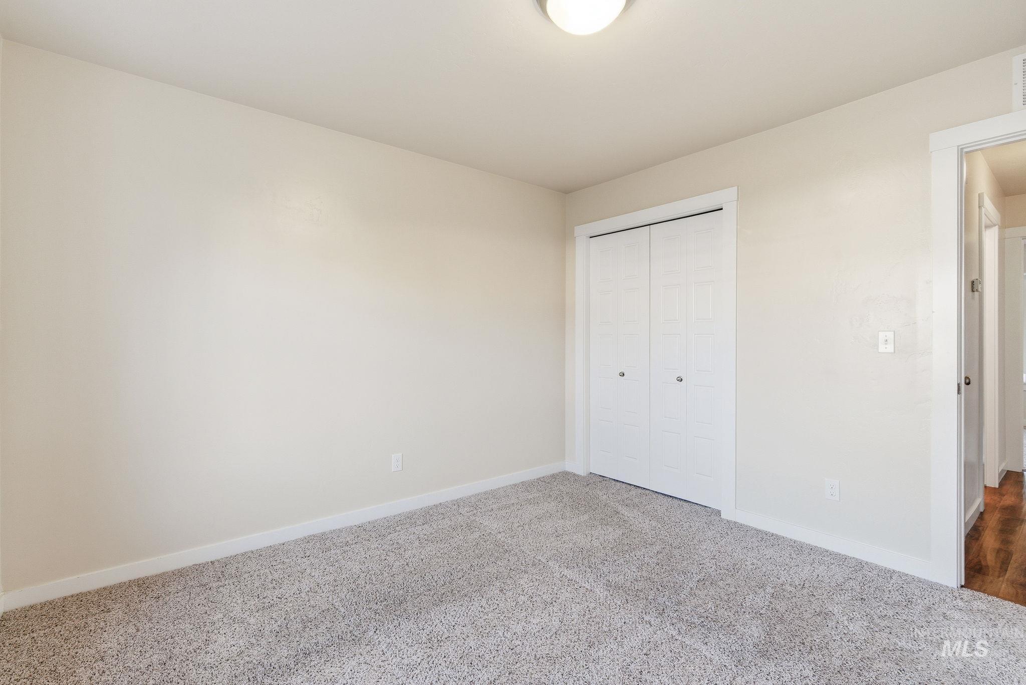 Unfurnished bedroom featuring carpet flooring and a closet