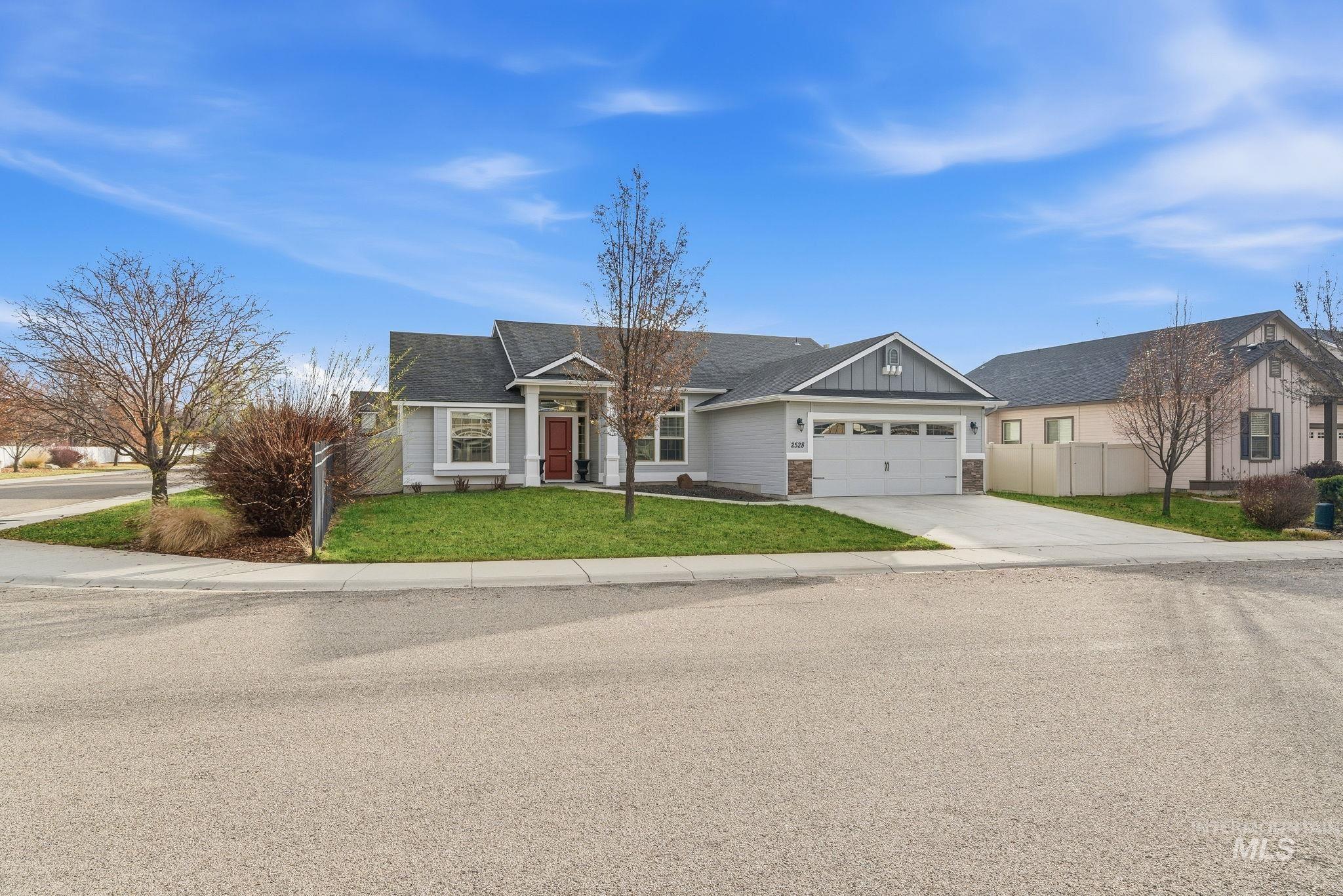 View of front of house featuring driveway, an attached garage, and board and batten siding