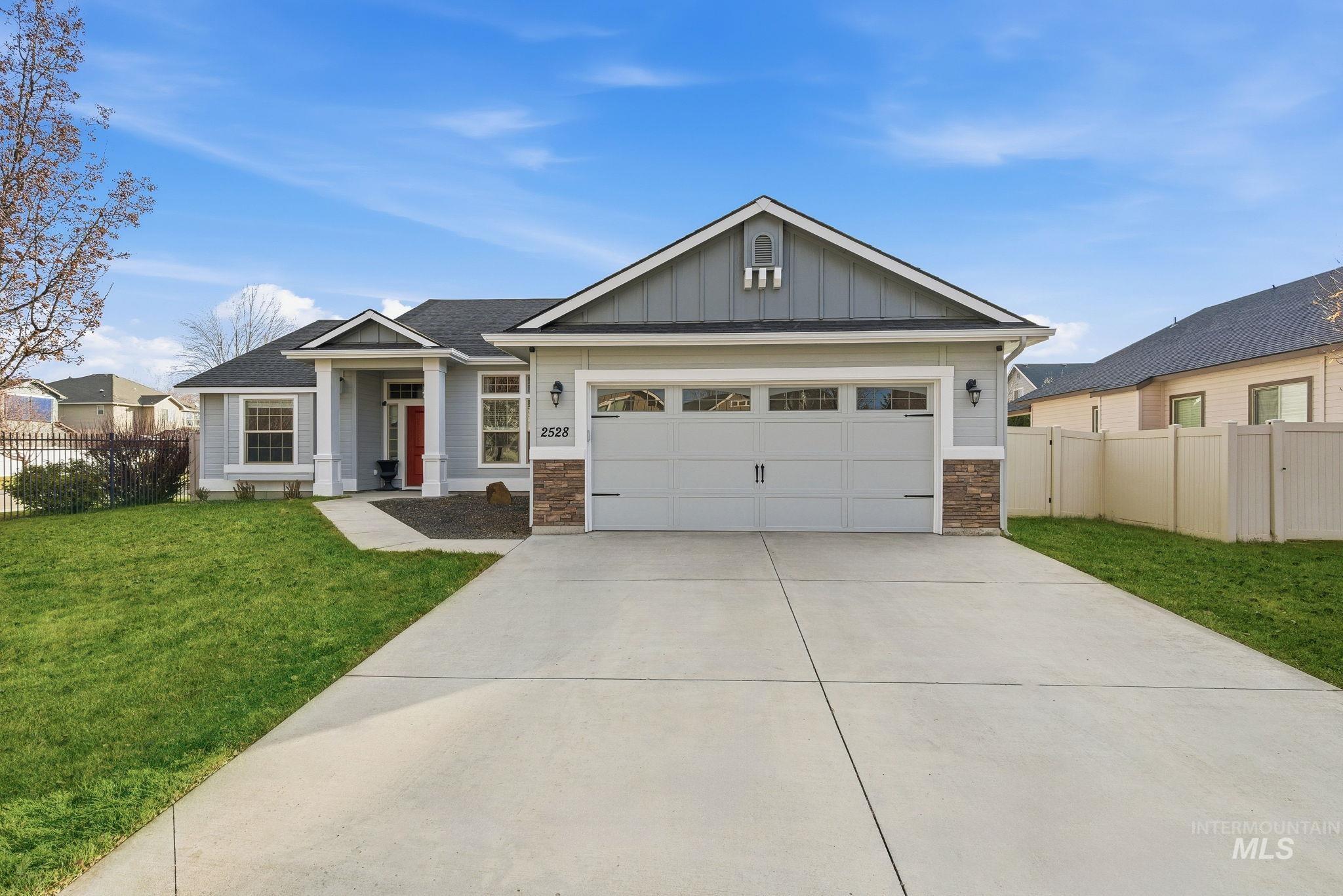 Craftsman inspired home featuring board and batten siding, concrete driveway, a garage, and stone siding