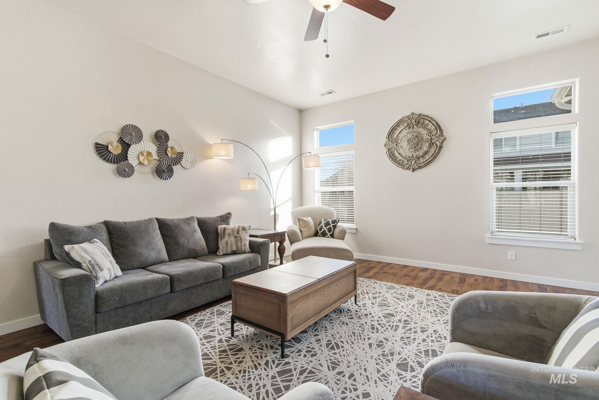 Living area featuring wood finished floors and ceiling fan