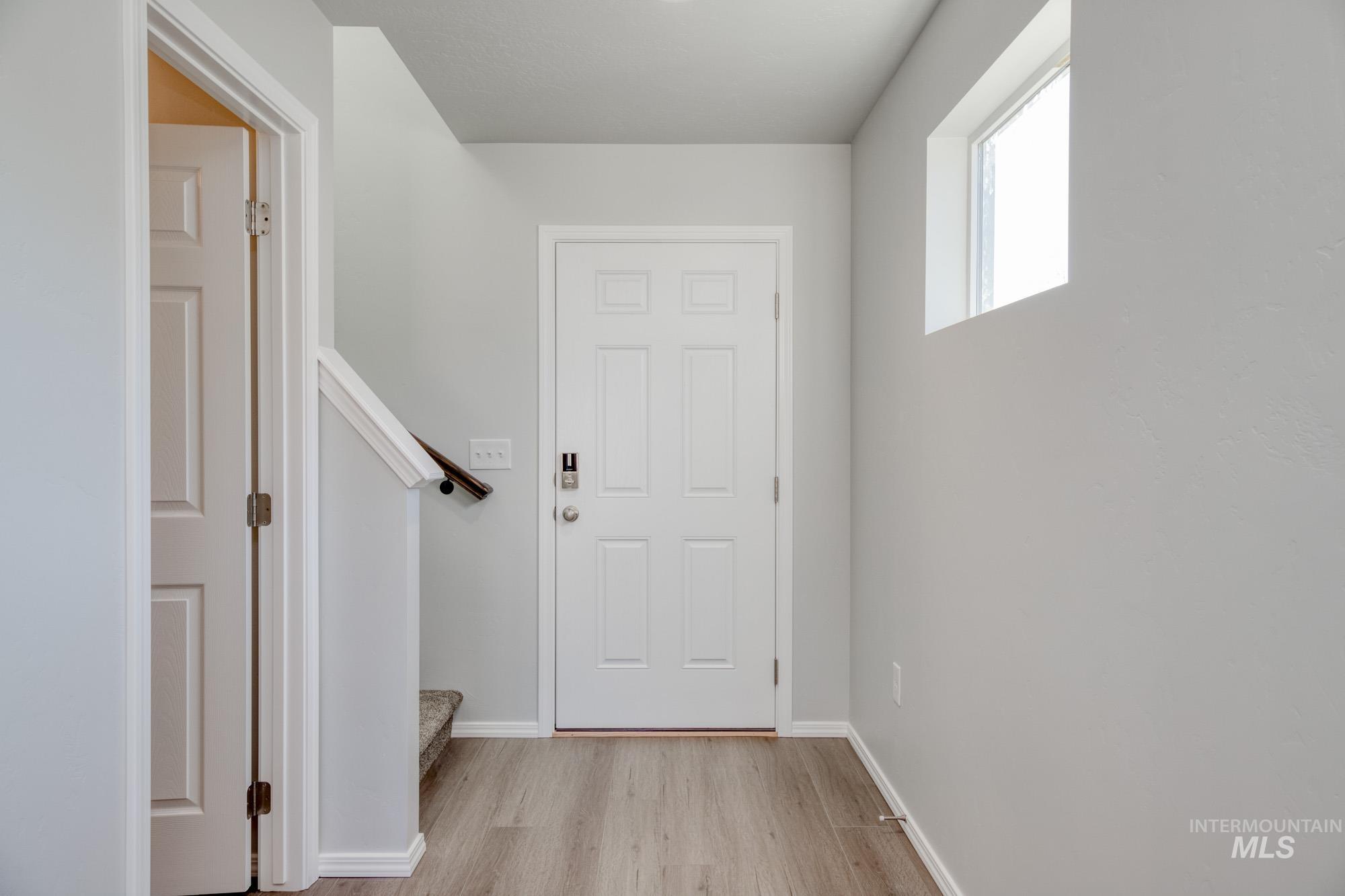 Entrance foyer with light wood finished floors and stairway