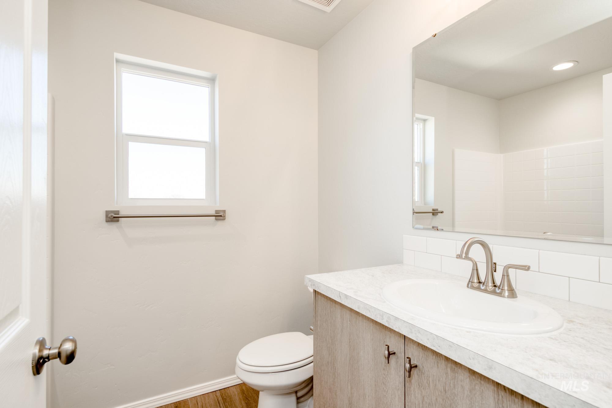 Bathroom with vanity and wood finished floors