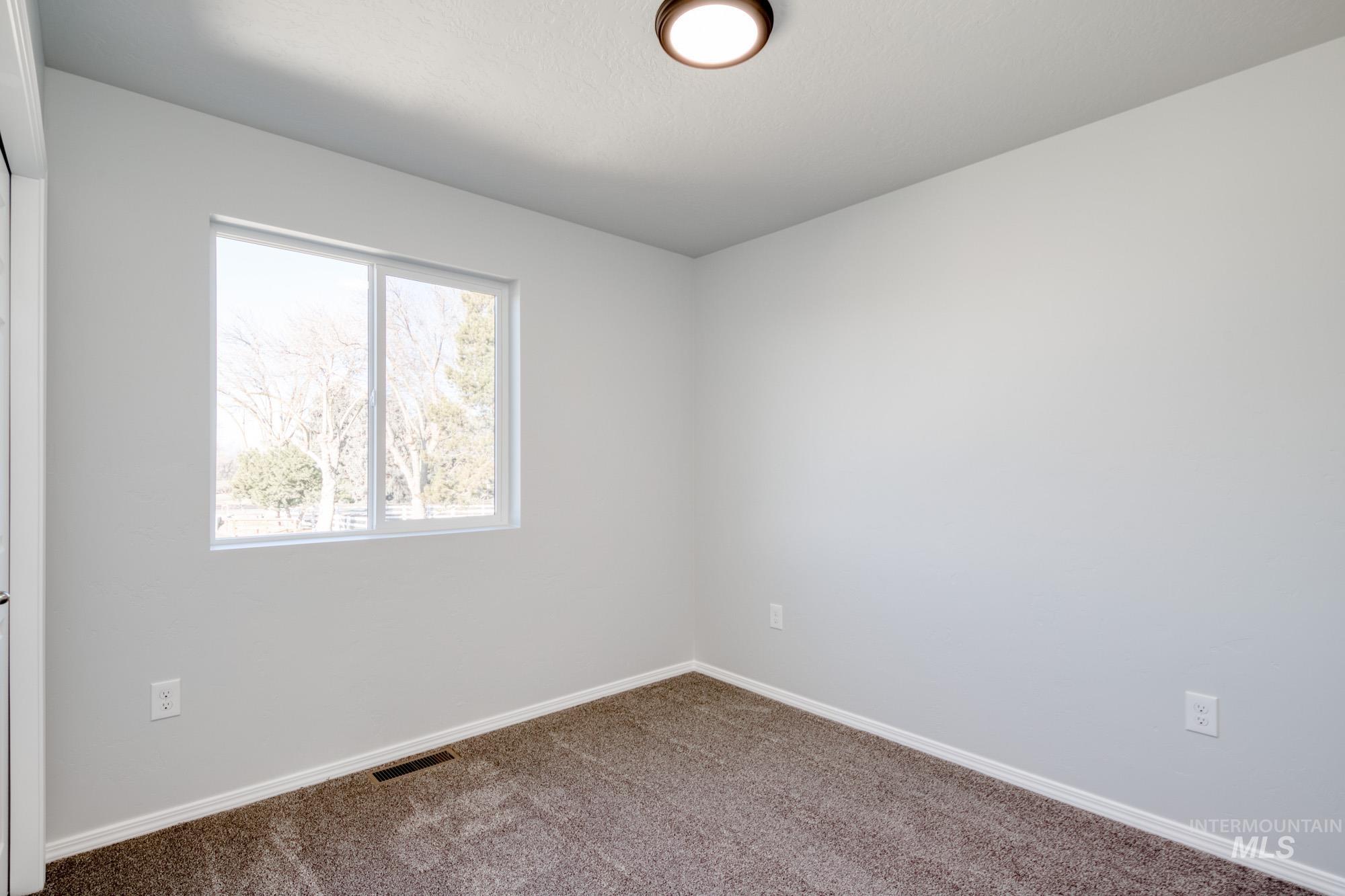 Spare room with carpet floors and baseboards