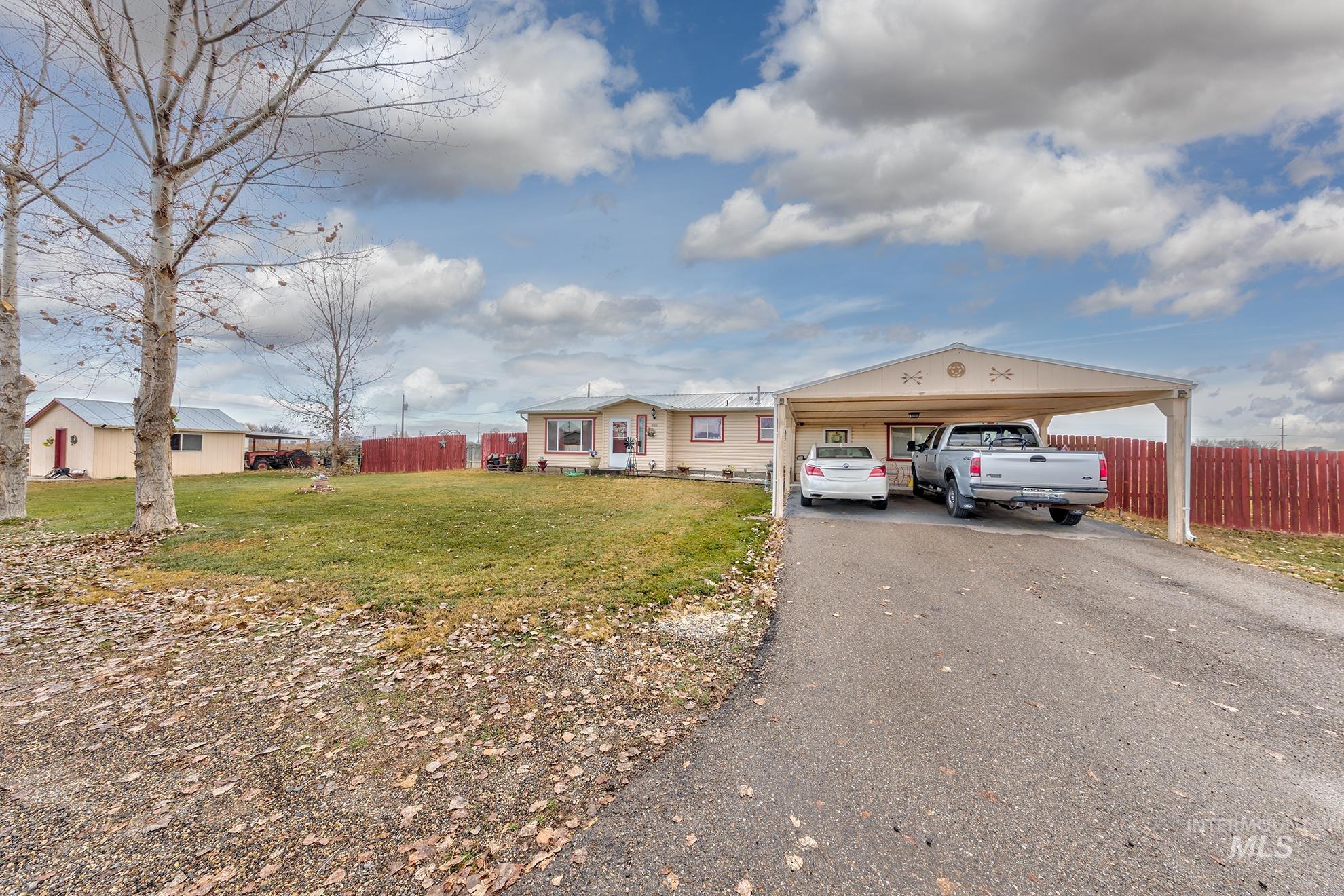 Single story home featuring asphalt driveway