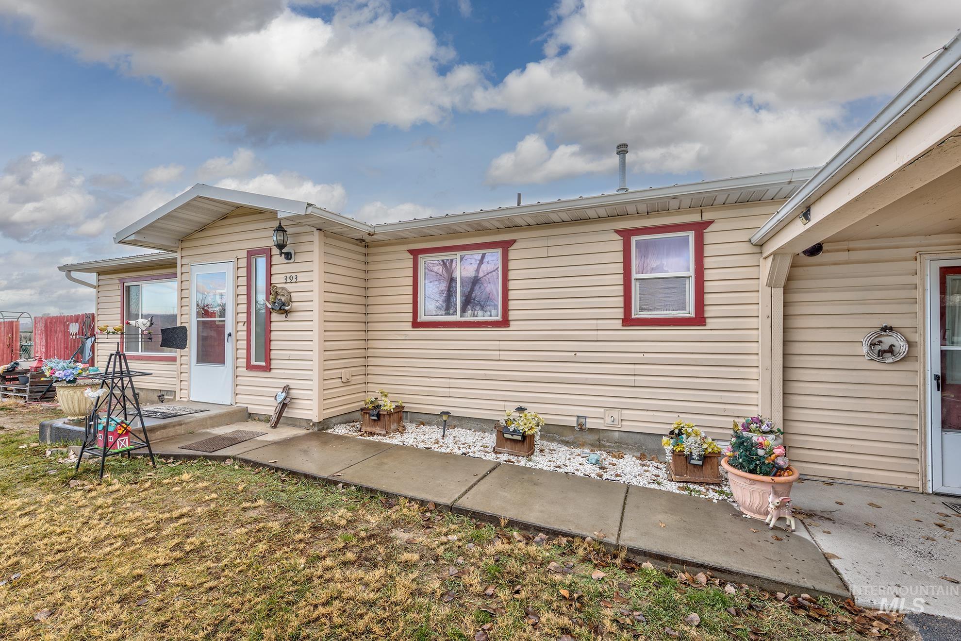 Back of property featuring a patio and a lawn