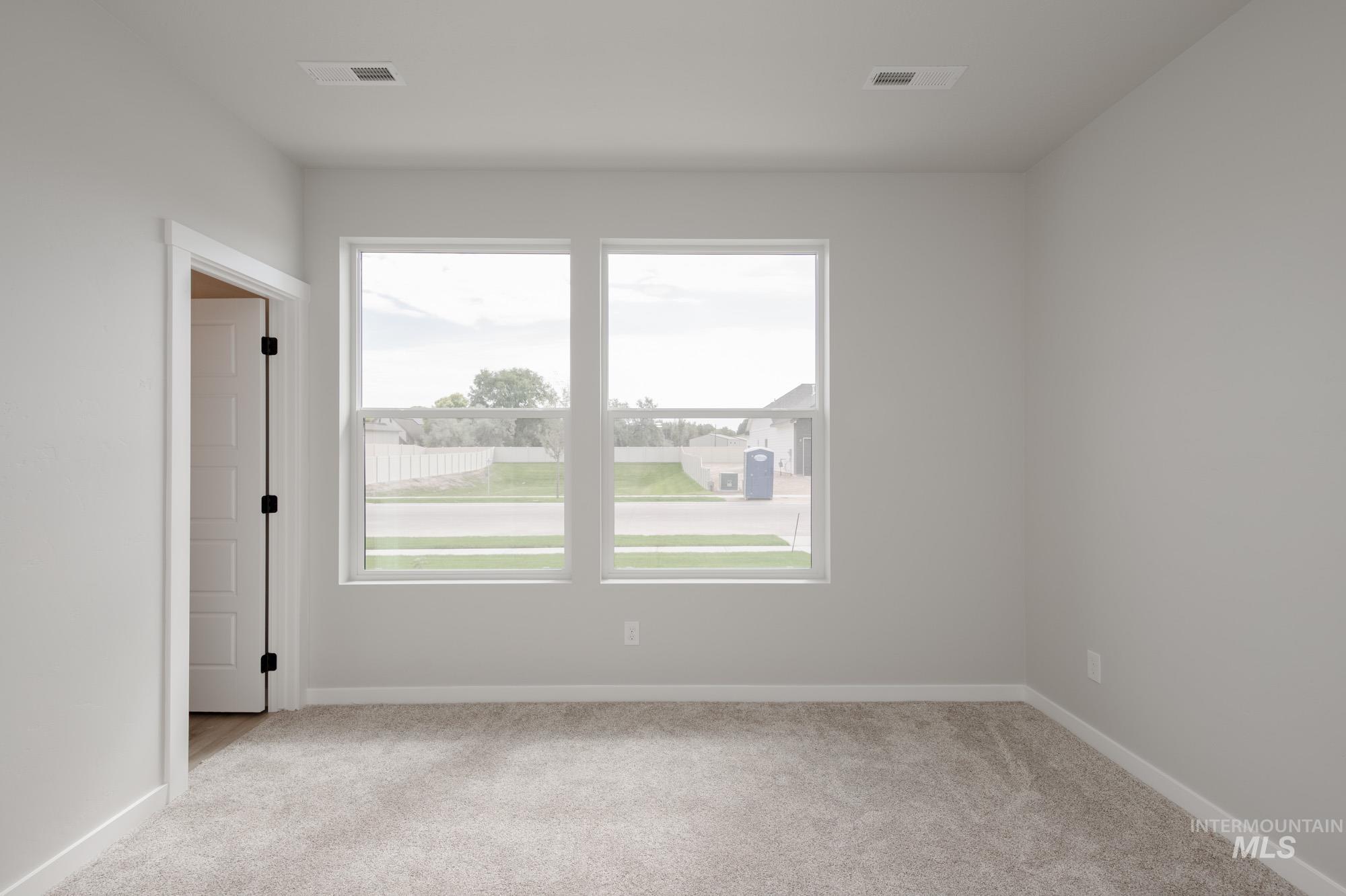 Unfurnished room with light carpet and baseboards