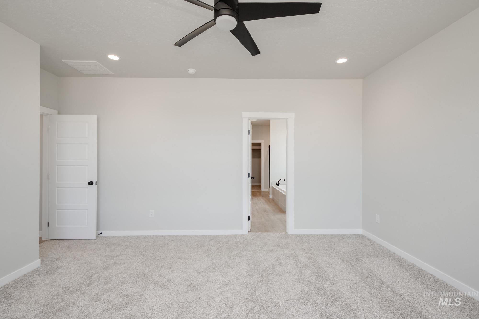 Unfurnished bedroom with ceiling fan, light colored carpet, and recessed lighting
