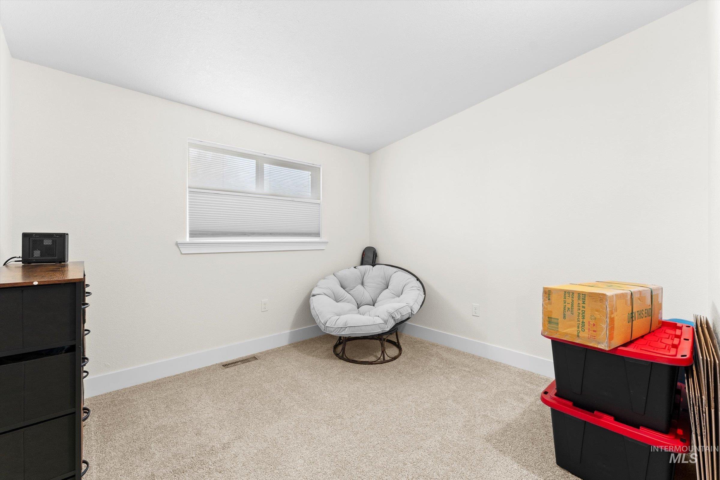Bedroom with light colored carpet and baseboards