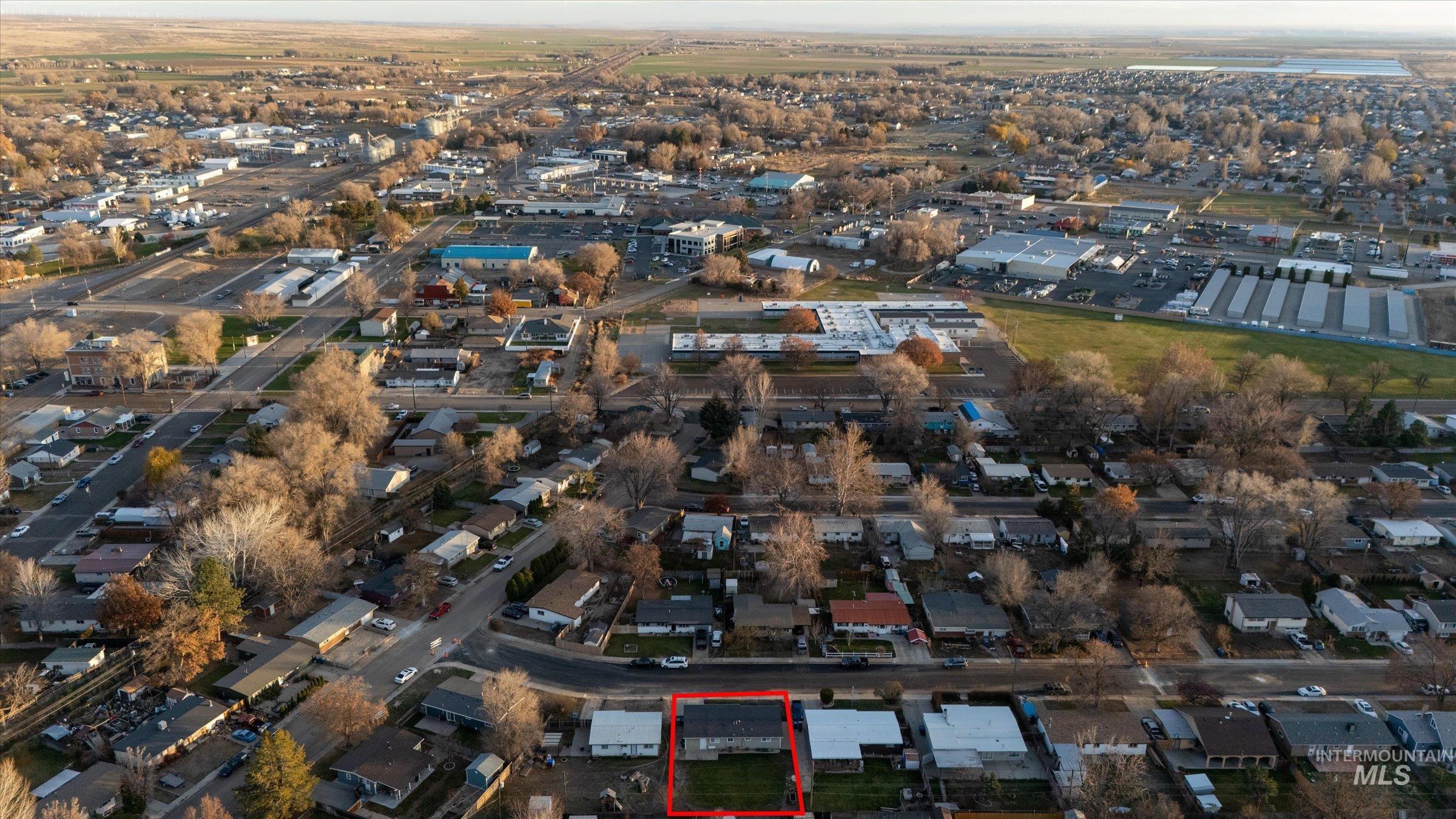 Aerial view of property and surrounding area featuring property boundaries highlighted
