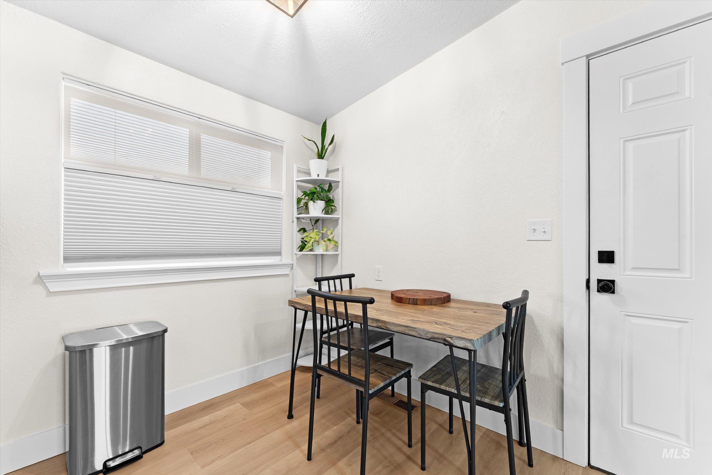 Dining room featuring light wood-style floors and baseboards