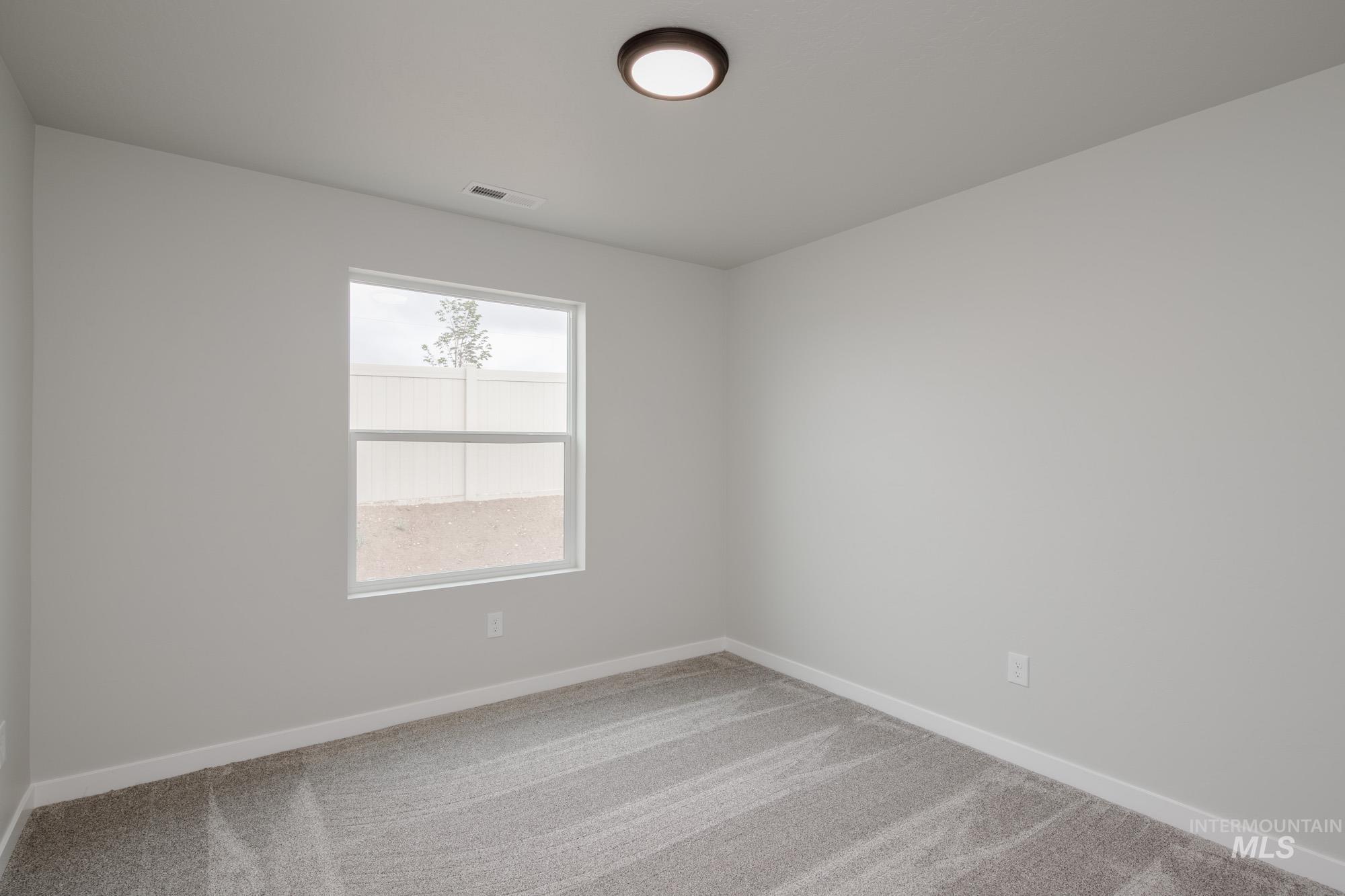 Unfurnished room with baseboards and carpet floors