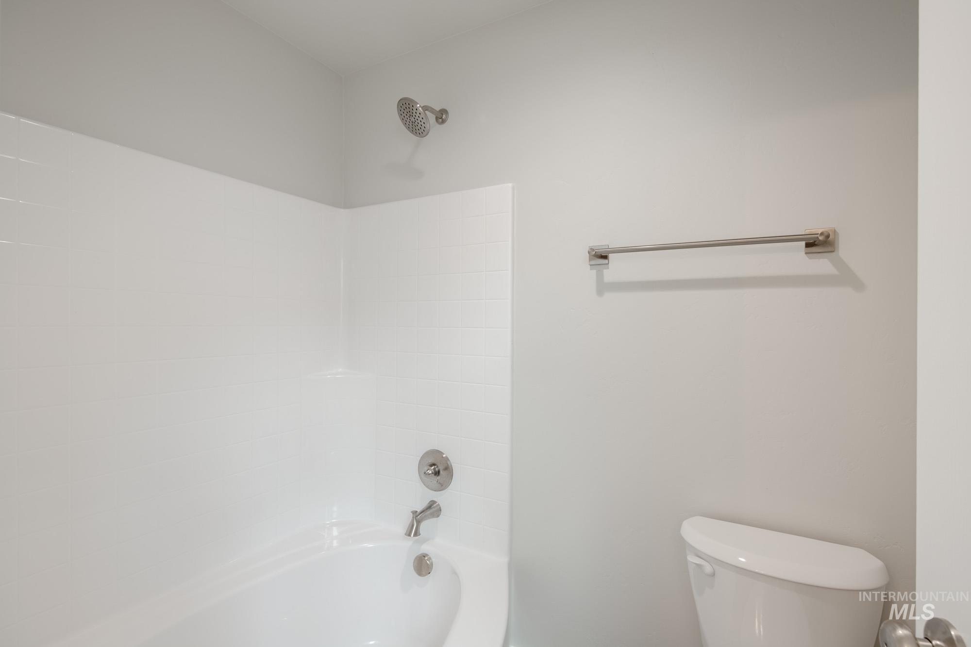 Full bath featuring toilet and  shower combination