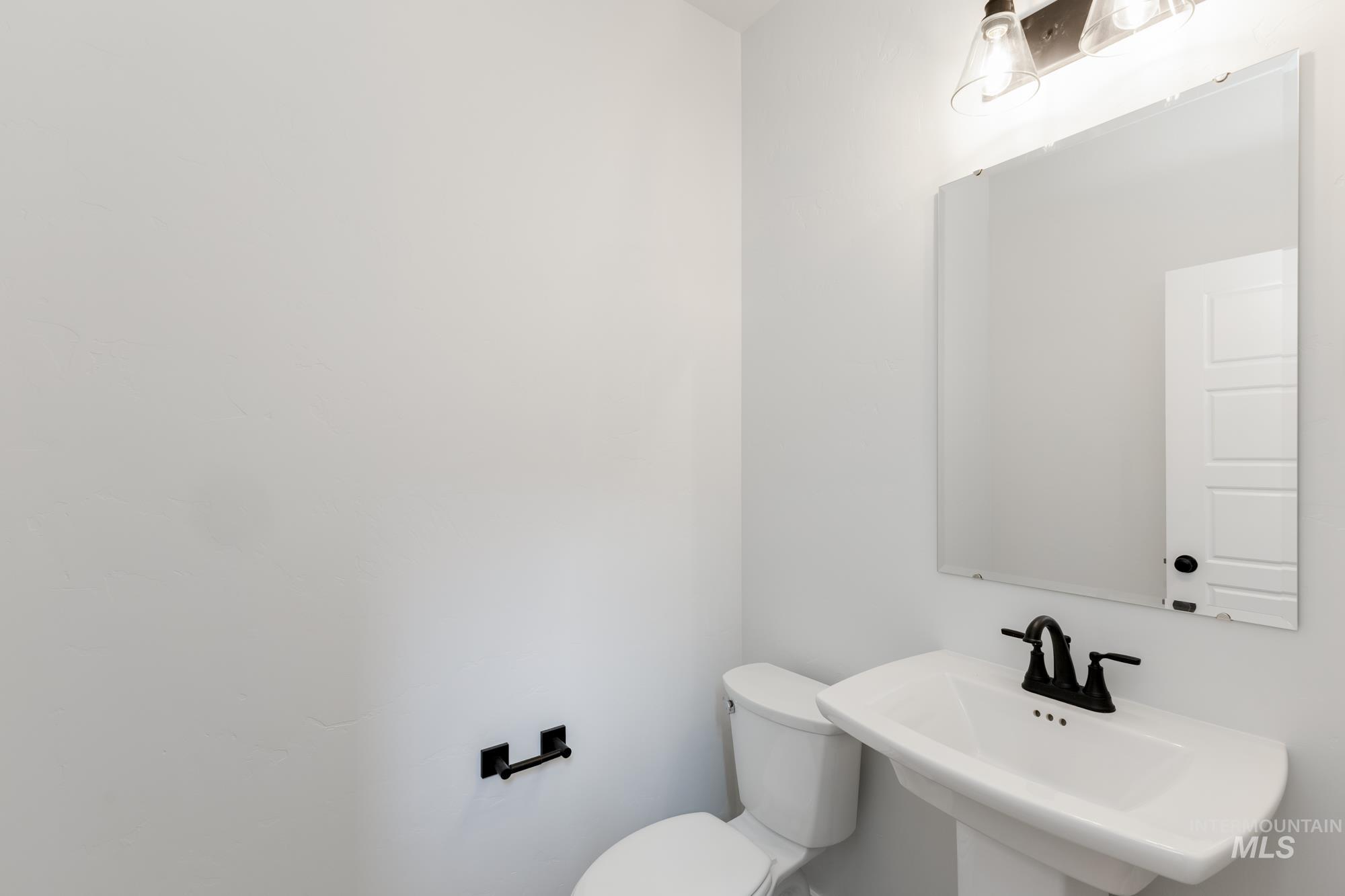 Half bath with toilet and a sink