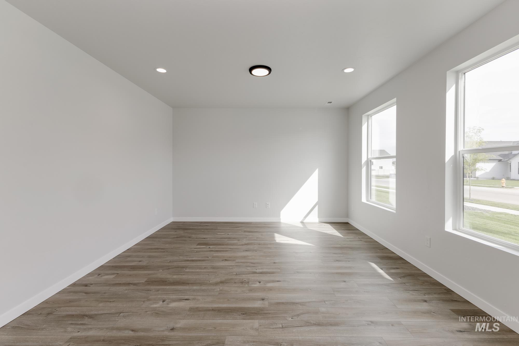 Spare room featuring light wood-style flooring and recessed lighting