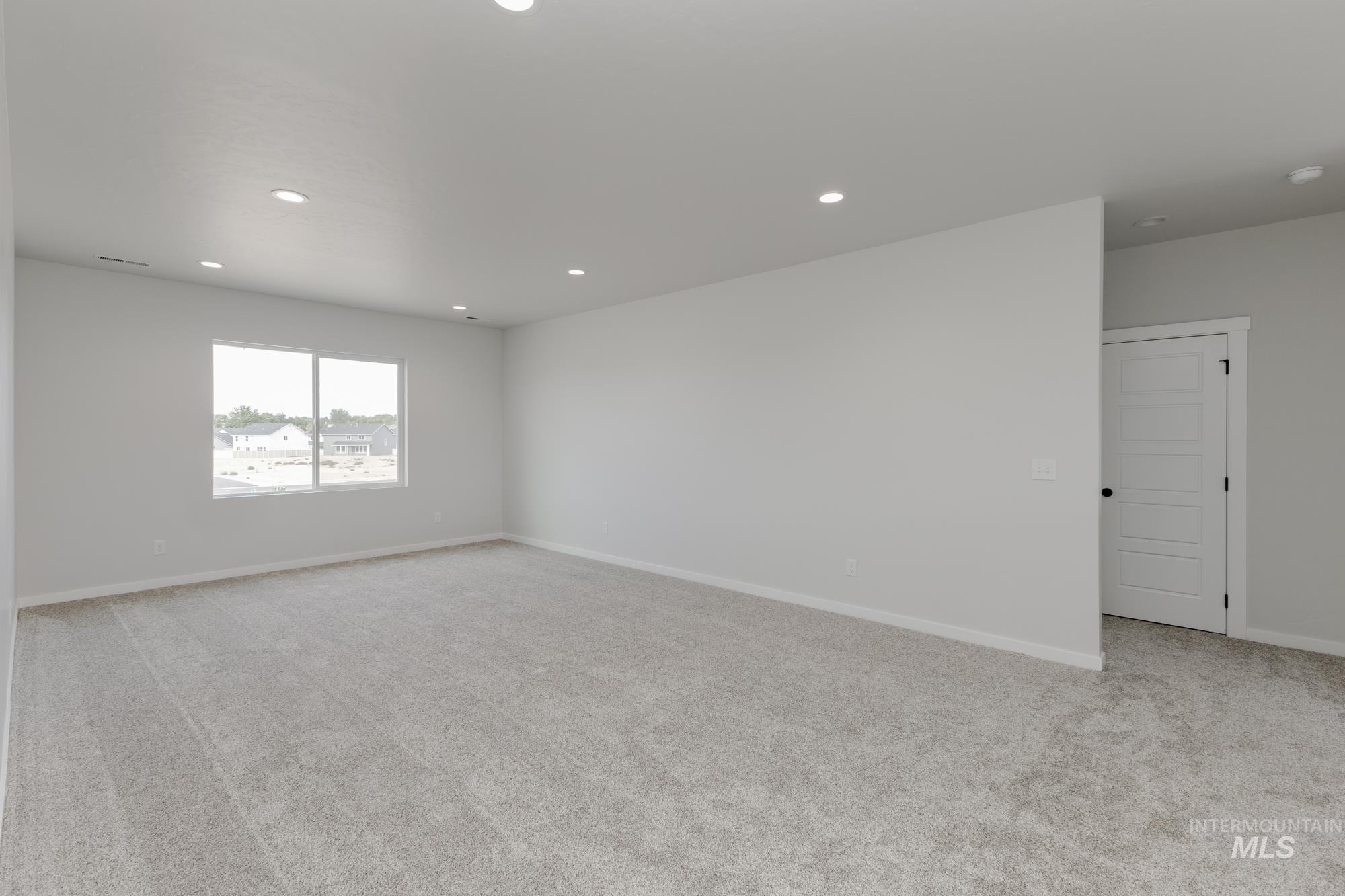 Spare room with light colored carpet and recessed lighting
