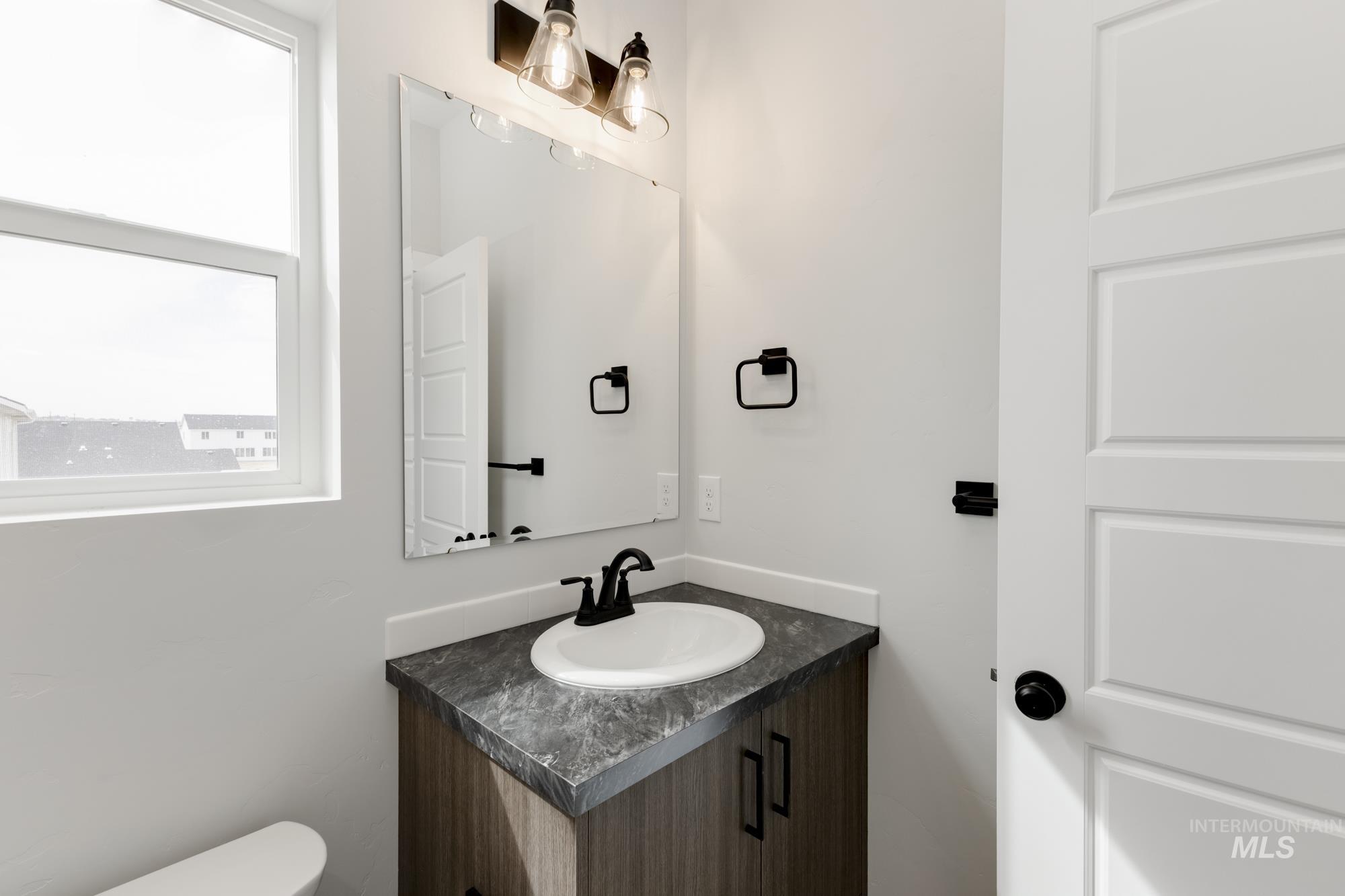 Half bath featuring vanity and toilet