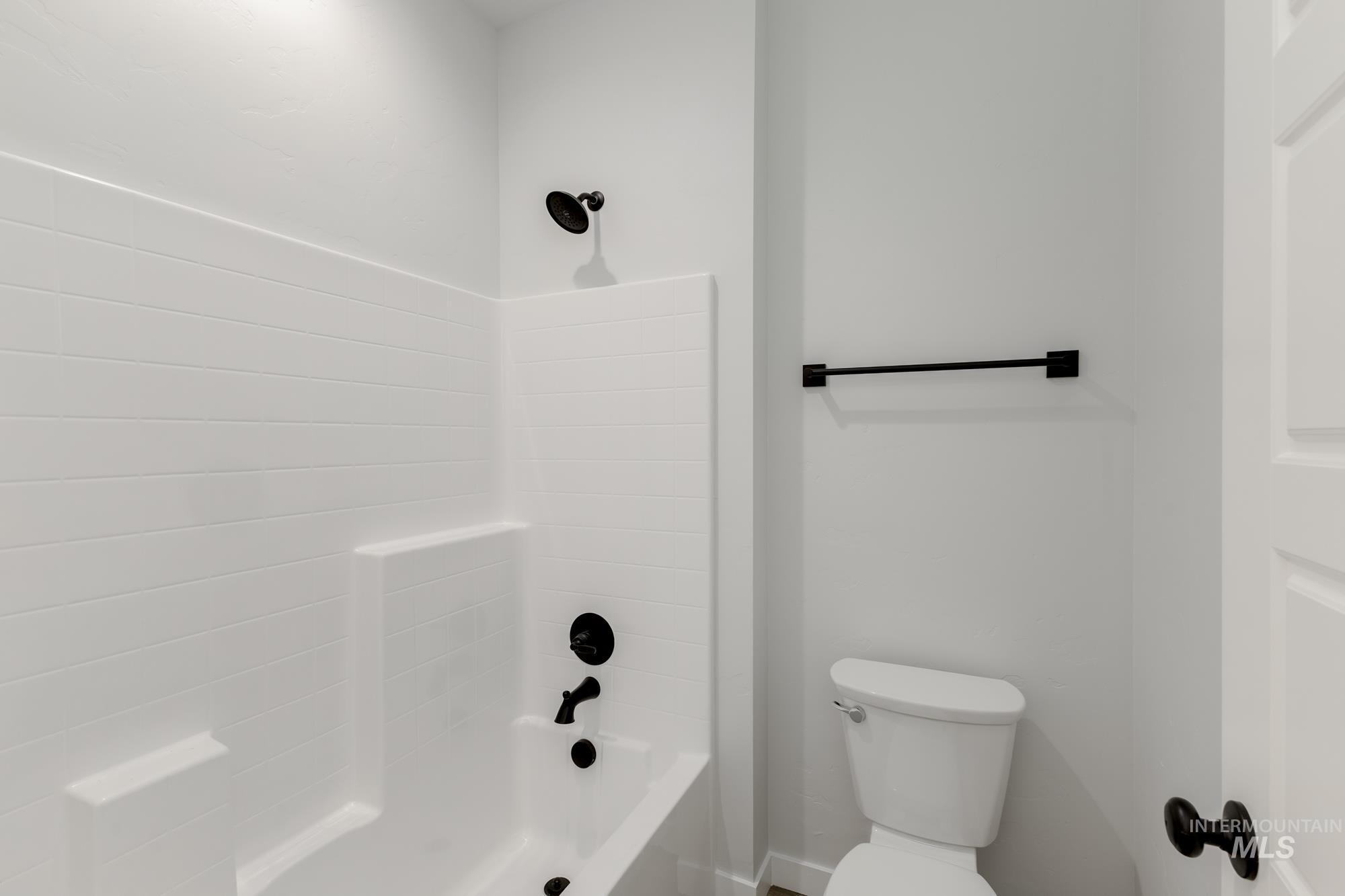 Full bath with bathing tub / shower combination and toilet