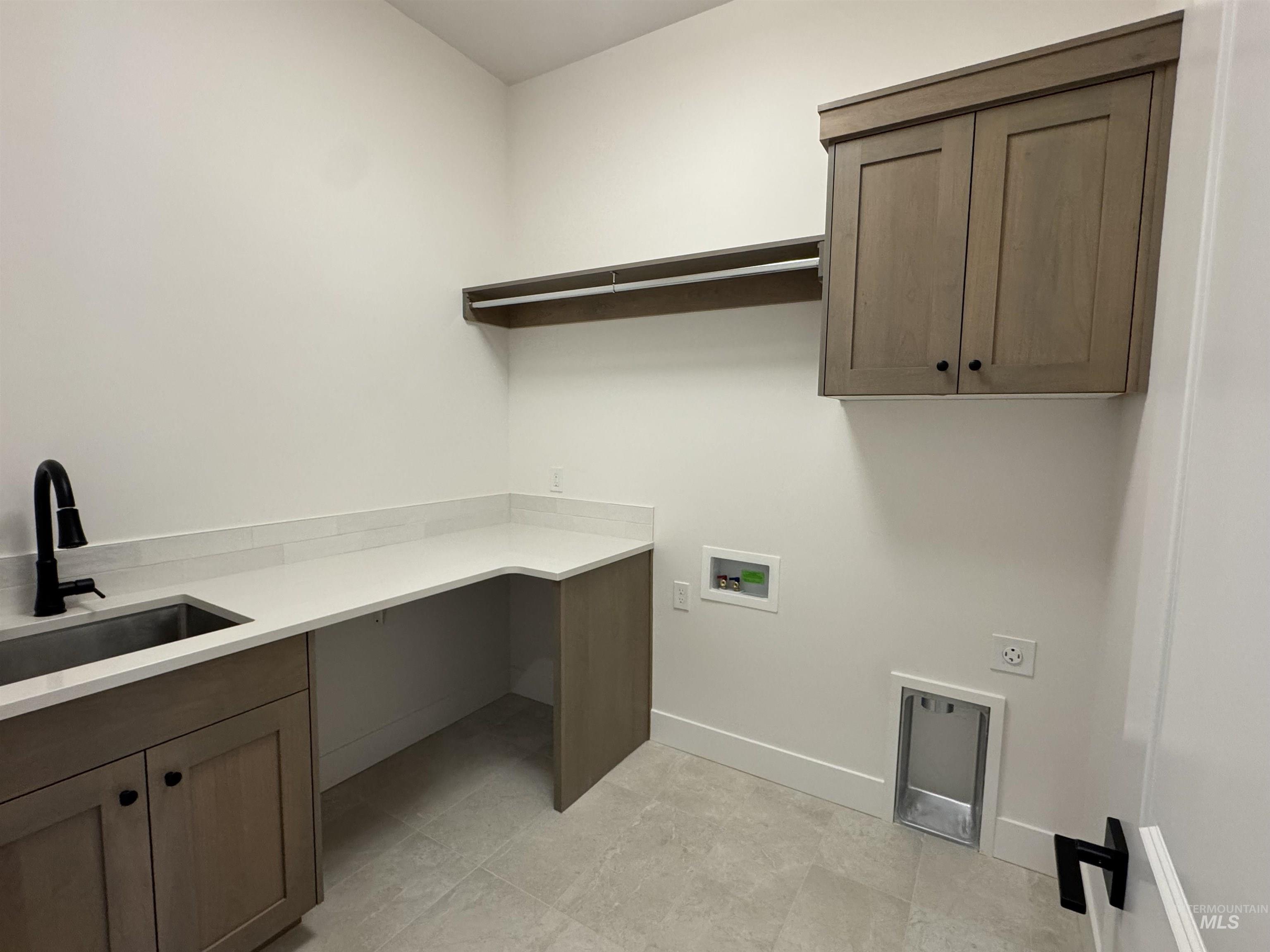 Laundry room featuring cabinet space, washer hookup, and electric dryer hookup