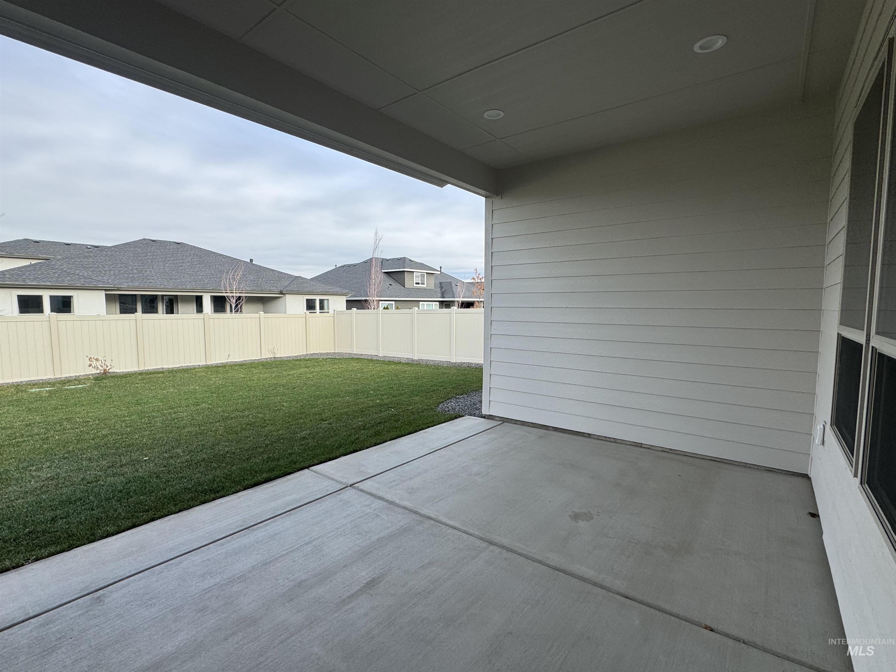 Fenced backyard with a patio