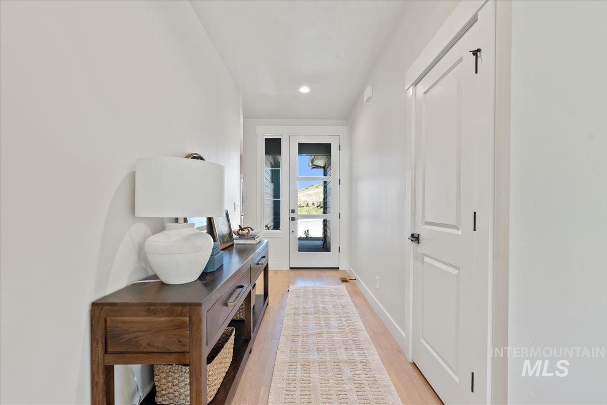 Entryway with wood finished floors and recessed lighting
