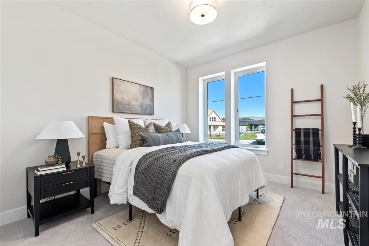 Bedroom with light carpet and baseboards