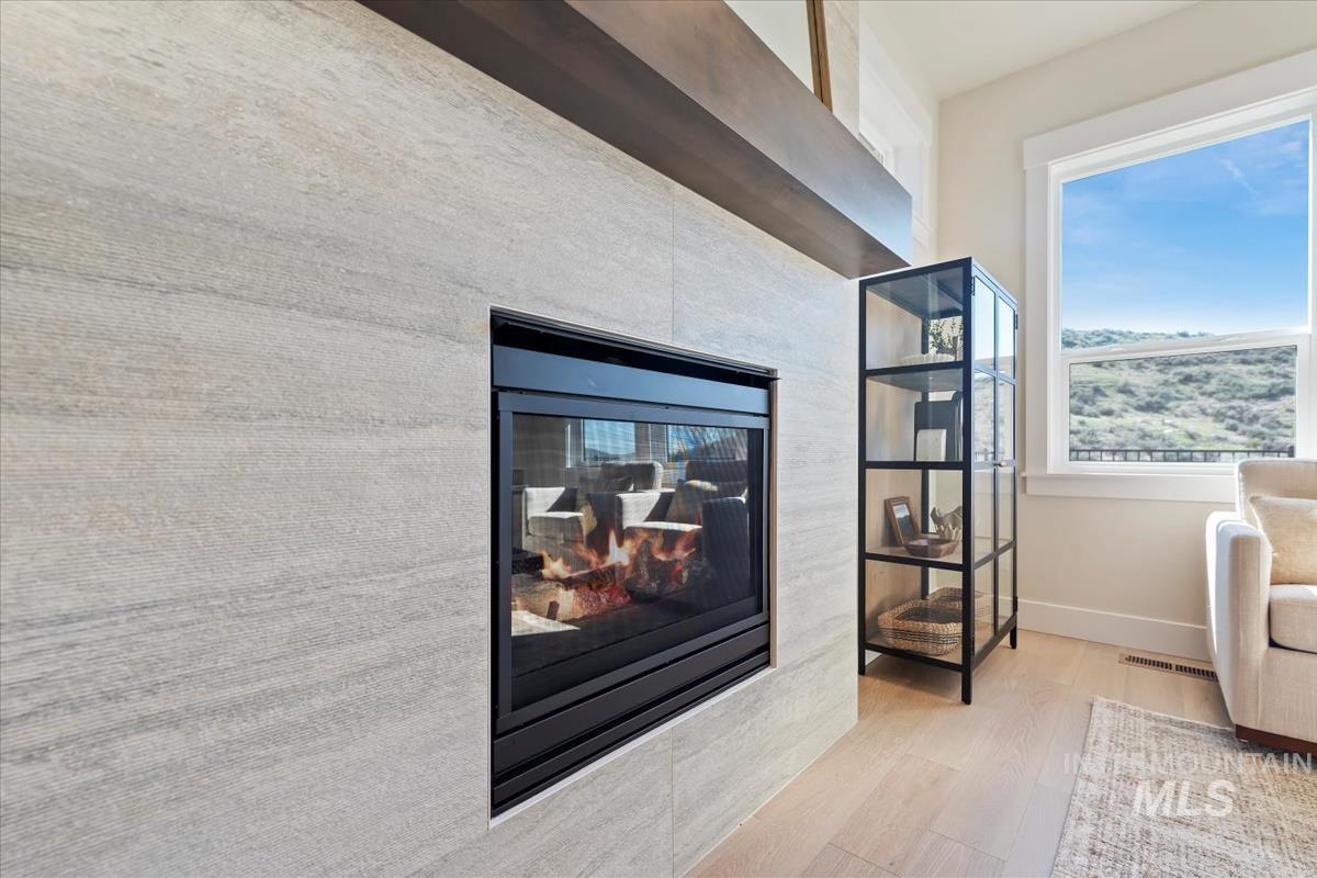 Detailed view of a multi sided fireplace and wood finished floors