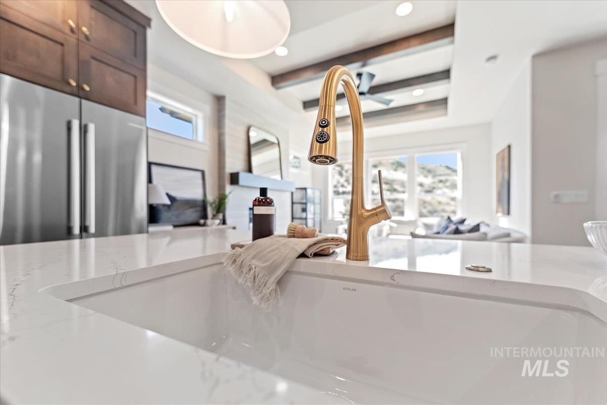Living room featuring healthy amount of natural light, beam ceiling, and recessed lighting