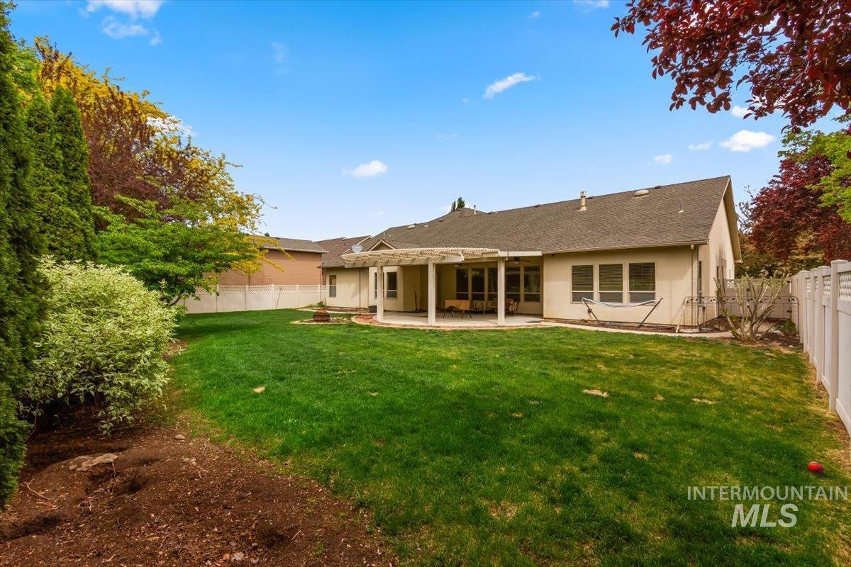 Back of house with a patio, a fenced backyard, and stucco siding