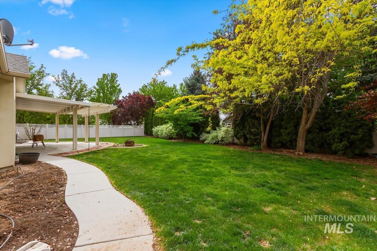 Fenced backyard featuring a pergola, a patio, and a fire pit