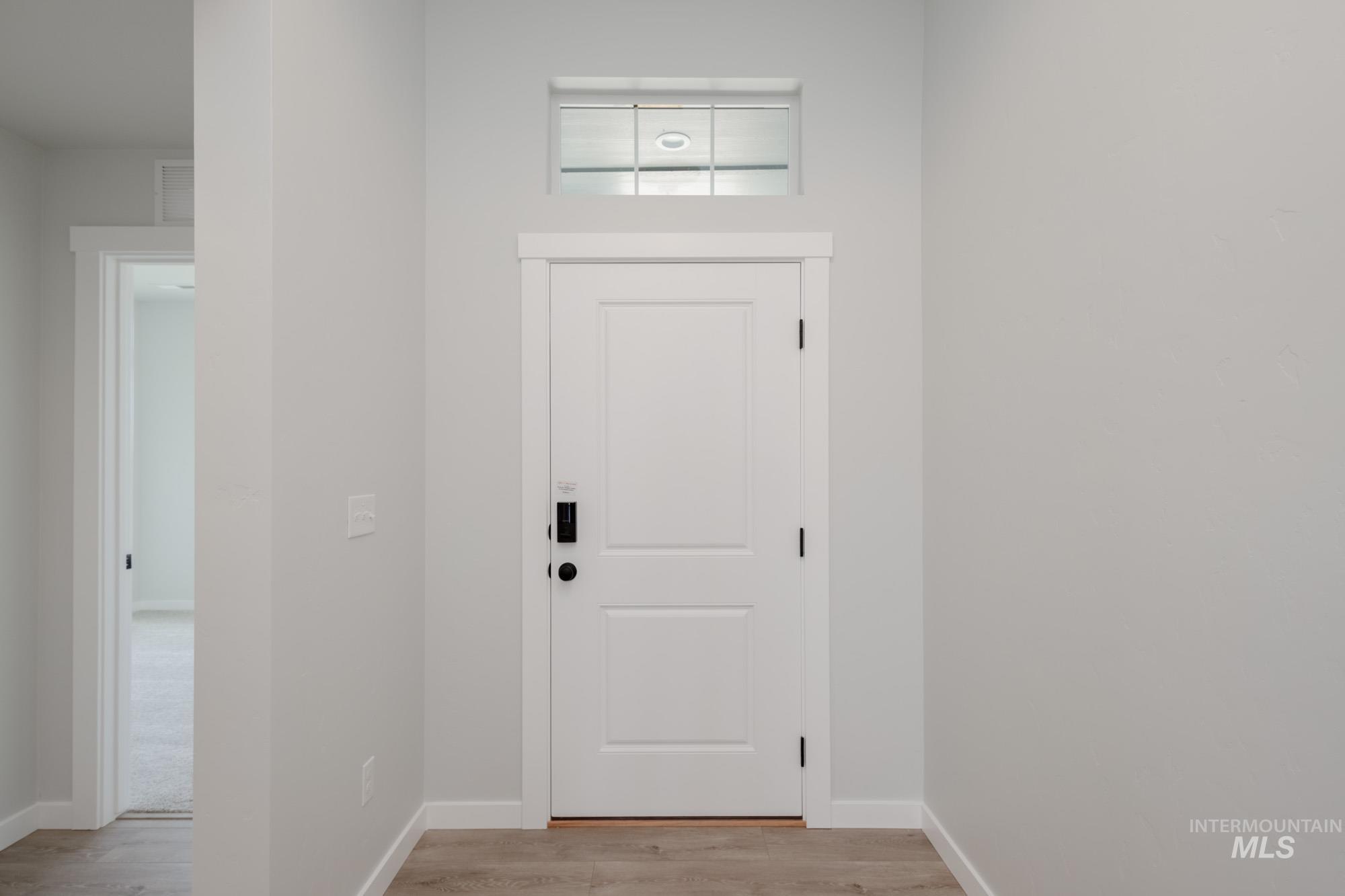 Entrance foyer featuring light wood finished floors and baseboards