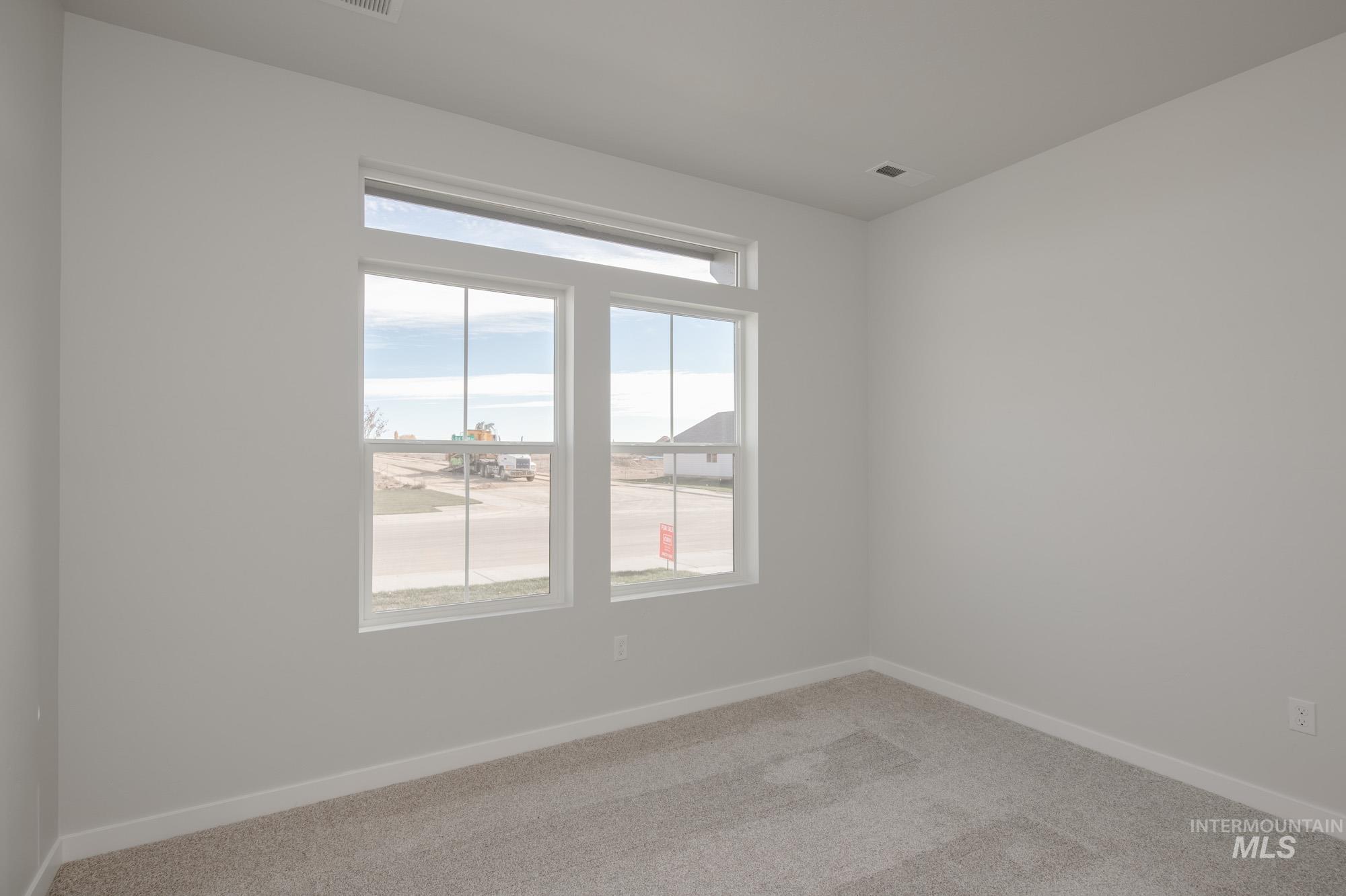 Unfurnished room featuring baseboards and carpet floors