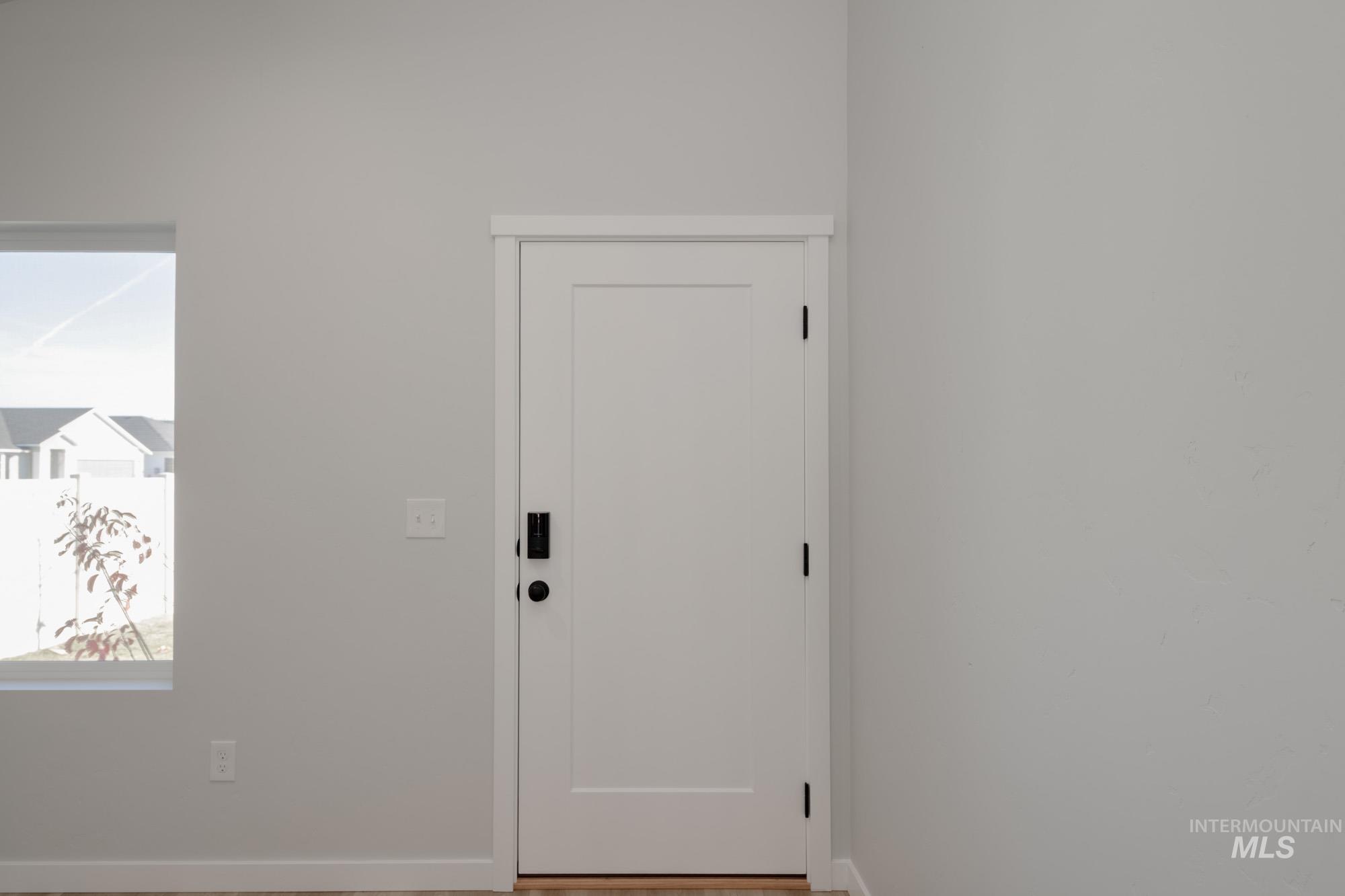 Entrance foyer with baseboards and wood finished floors