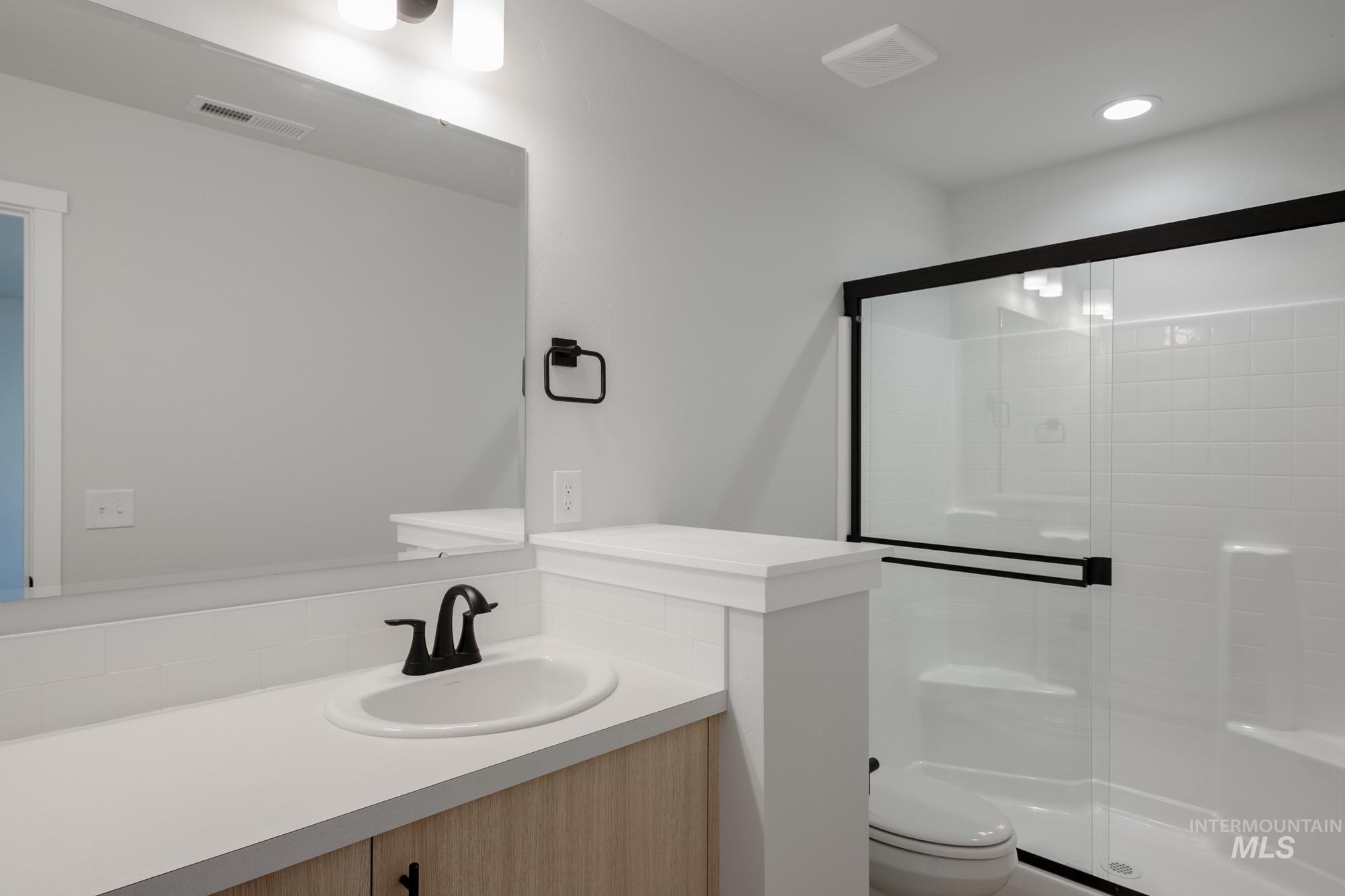 Bathroom with vanity and a stall shower