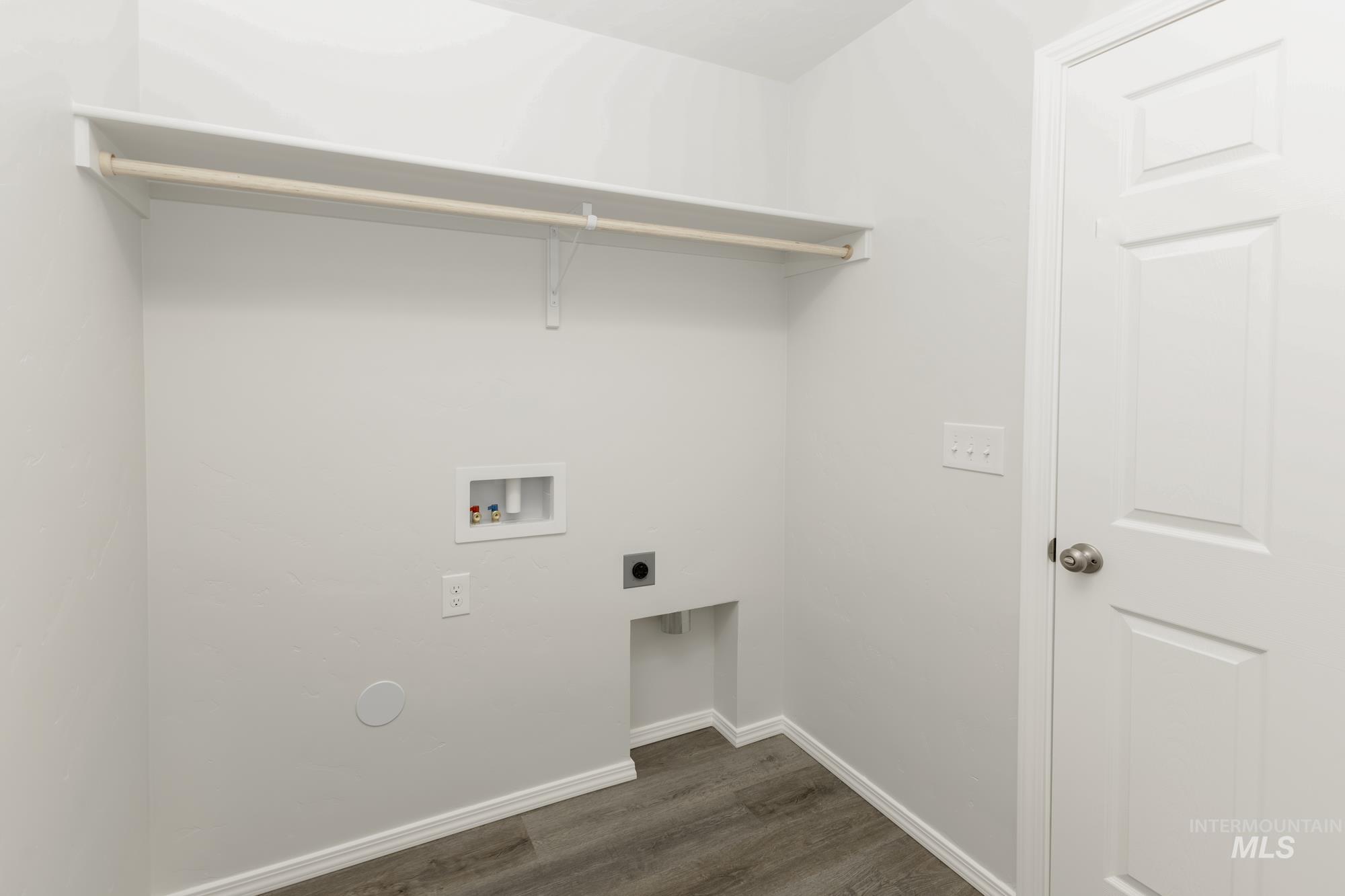 Washroom with dark wood finished floors, washer hookup, and electric dryer hookup
