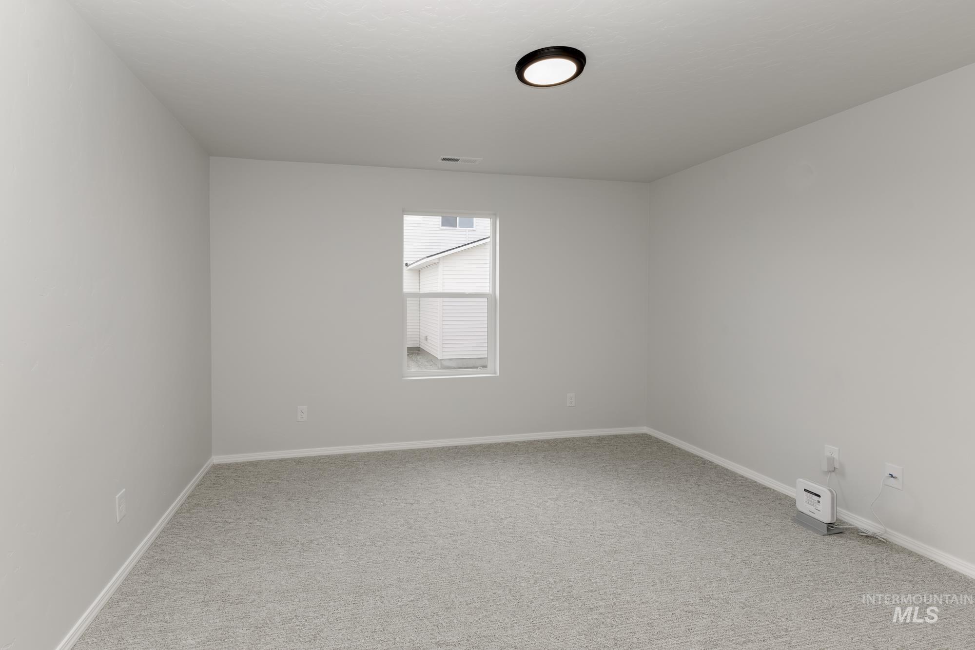 Unfurnished room with light carpet and baseboards