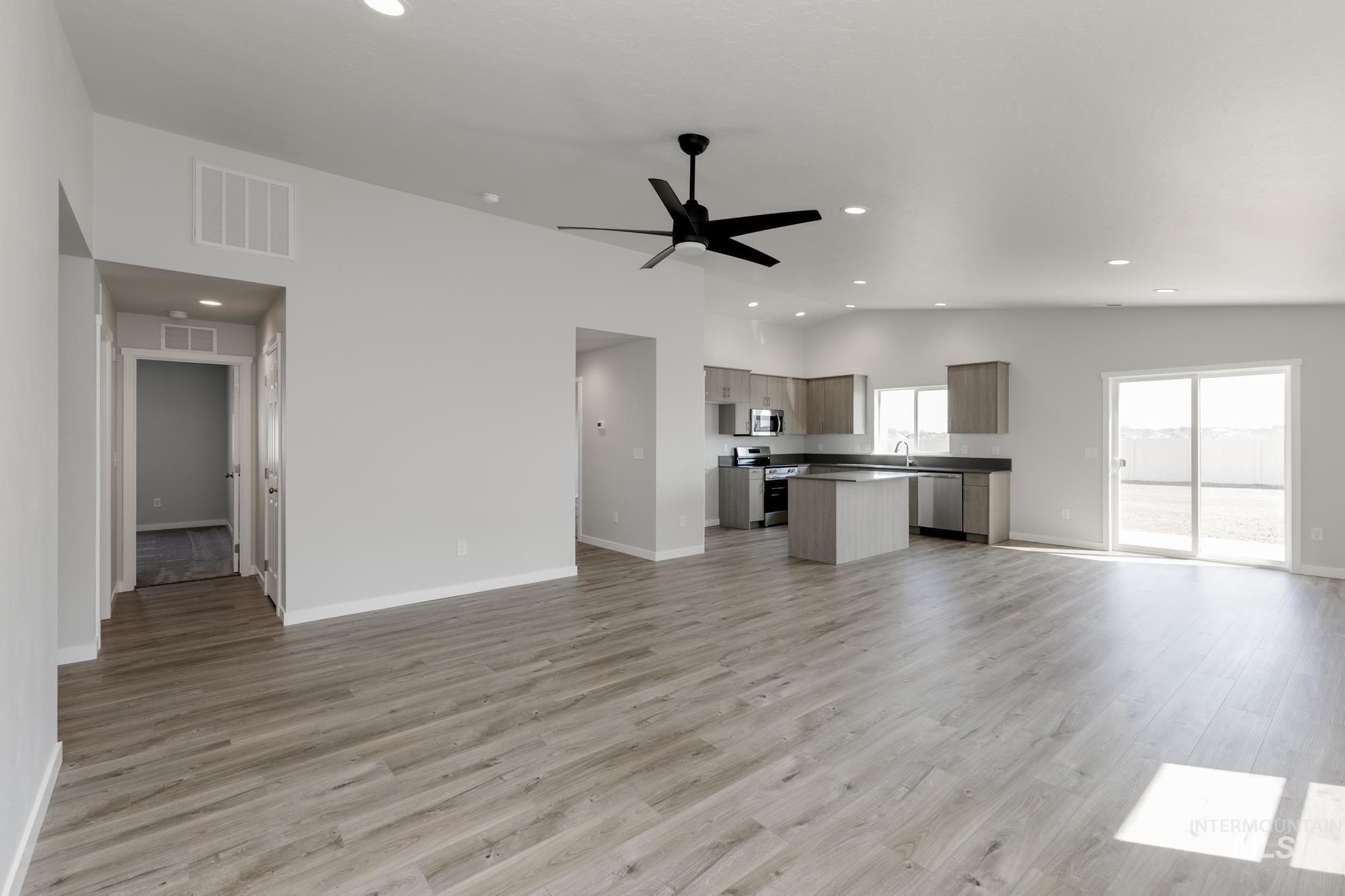Unfurnished living room featuring light wood finished floors, recessed lighting, and a ceiling fan