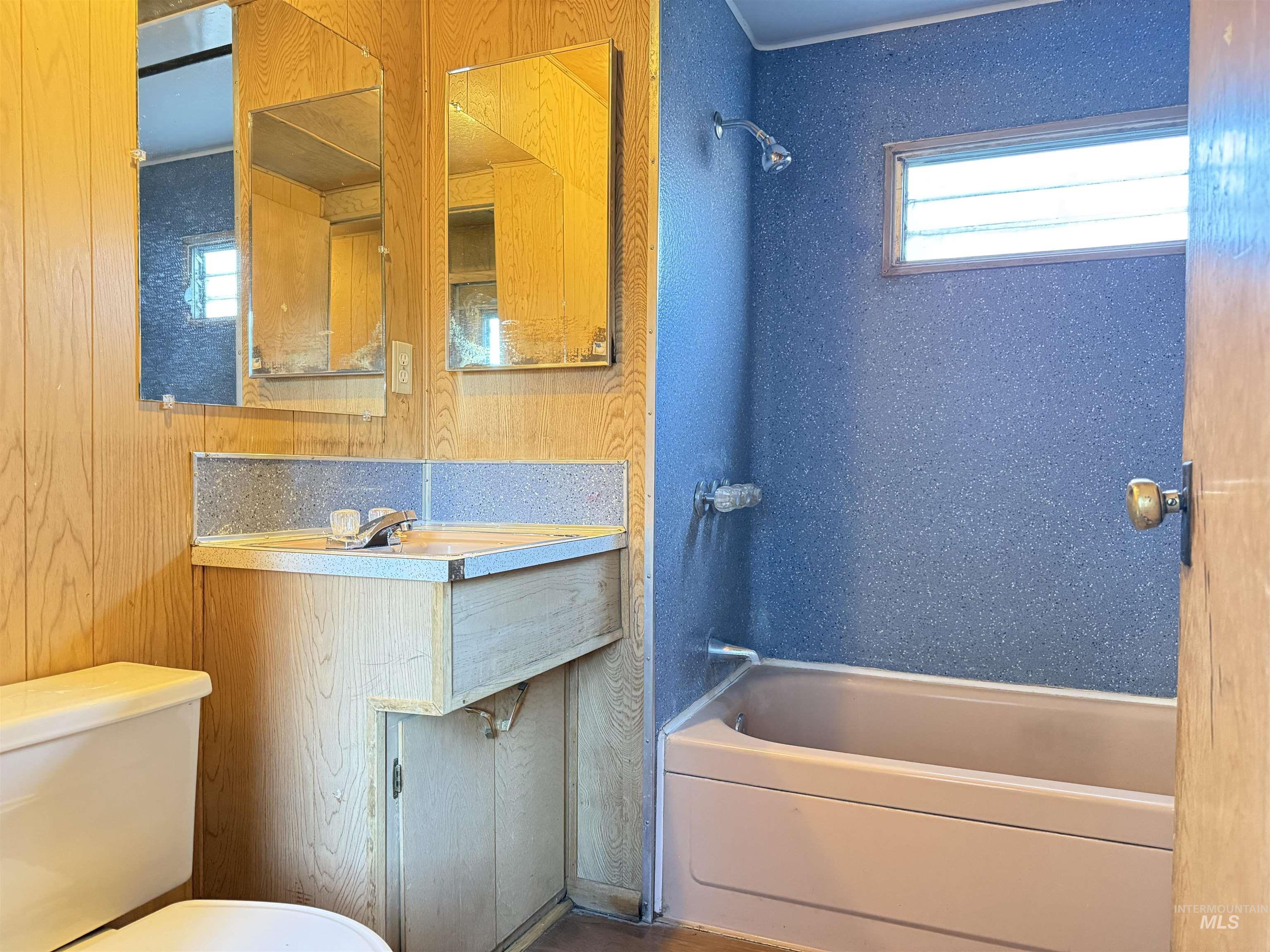 Bathroom featuring tub / shower combination and vanity