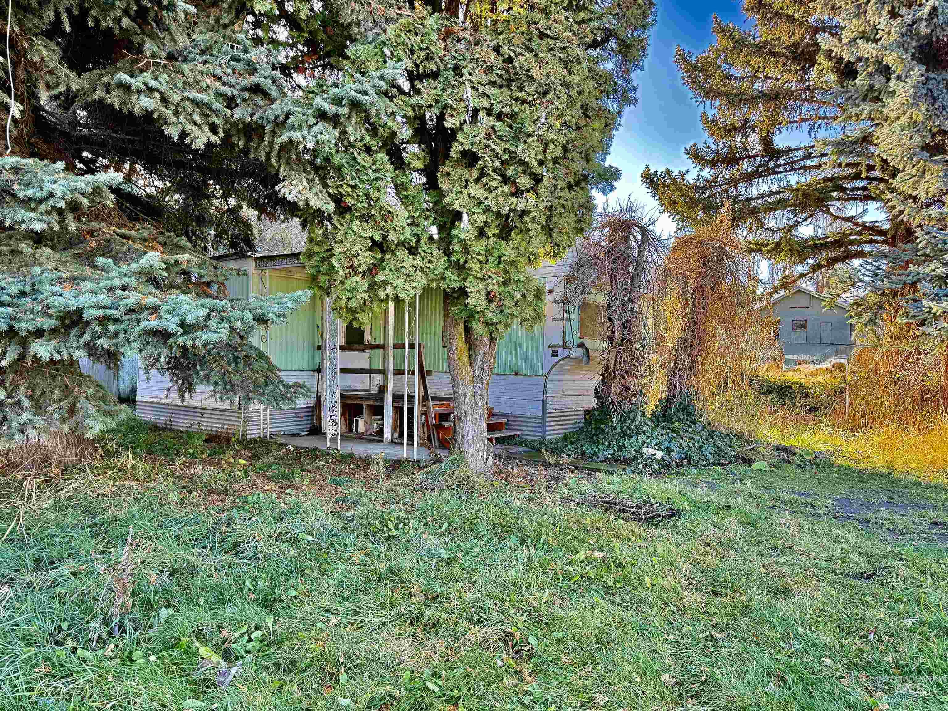 View of side of home with a lawn and a patio area