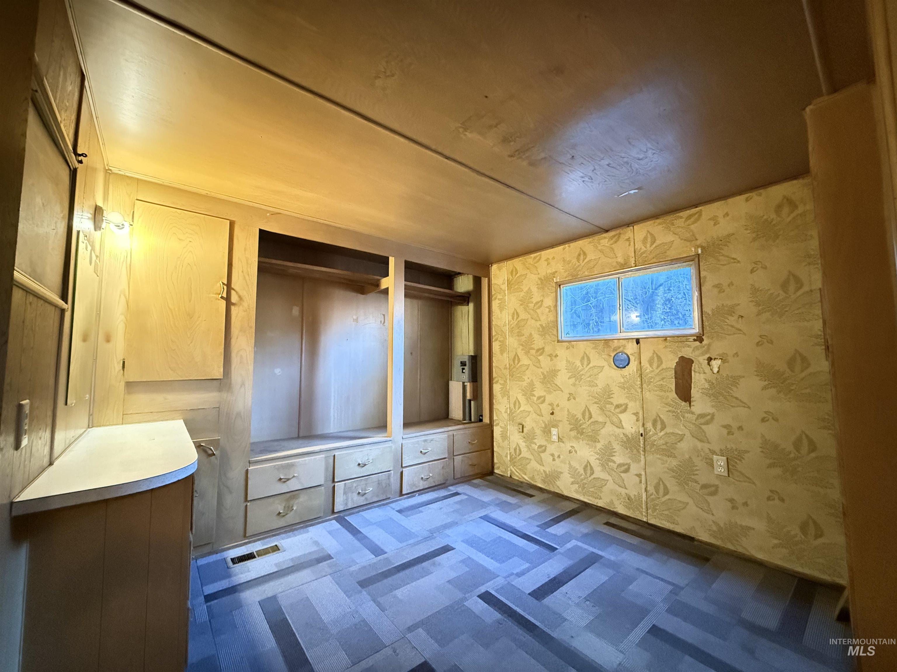 Empty room with wallpapered walls