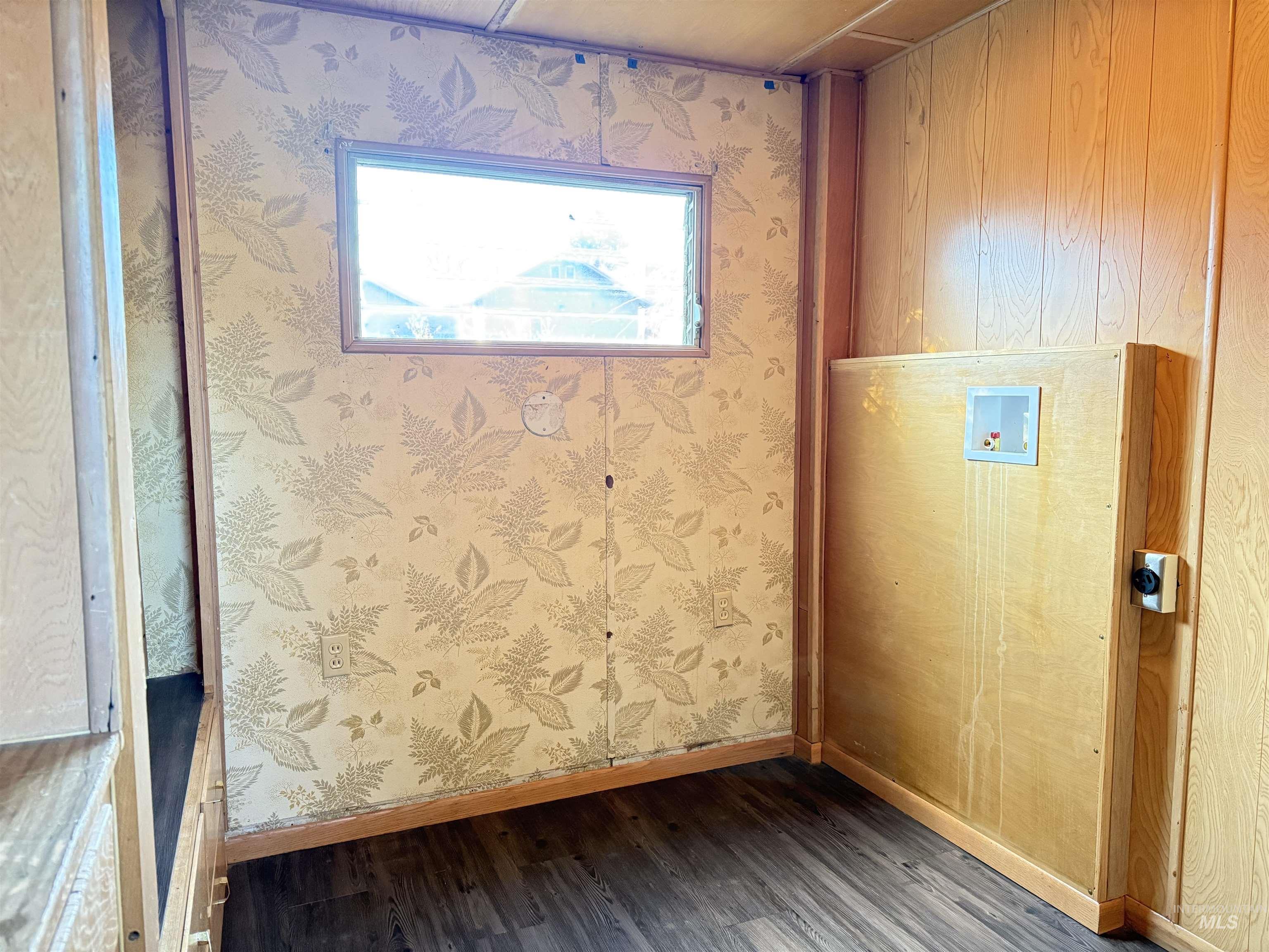 Doorway to outside with wood finished floors and baseboards