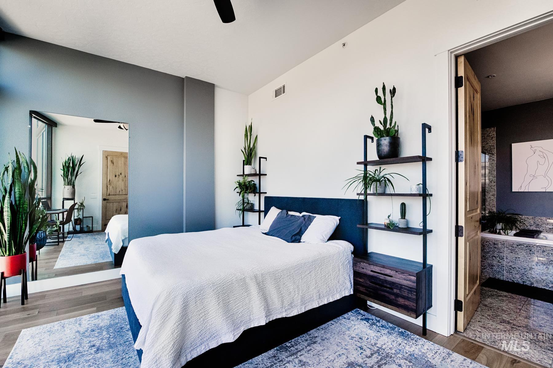 Bedroom featuring wood finished floors and ceiling fan